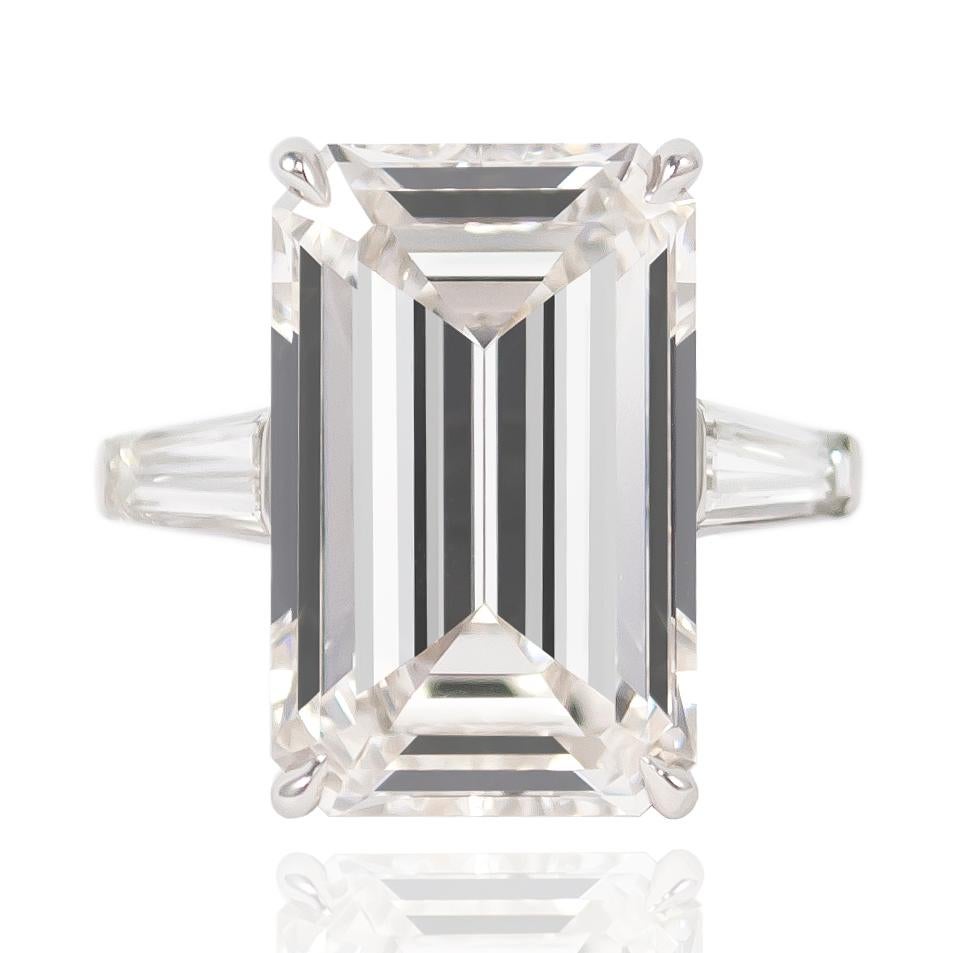 This exquisite J. Birnbach original features a GIA Certified 10.03 ct Emerald cut diamond of J color and SI1. Flanked by a pair of tapered baguettes = approximately 1.50 ctw set in a platinum mounting, this ring will forever remain a classic and