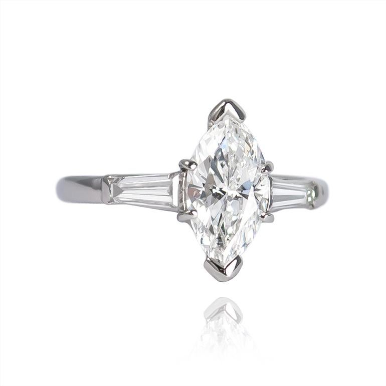 This sweet engagement ring features the next trending shape for engagement rings in a timeless setting. The center diamond is a 1.01 carat marquise certified by GIA to be D color and I1 clarity. The tapered baguettes are 0.68 carats total, and draw