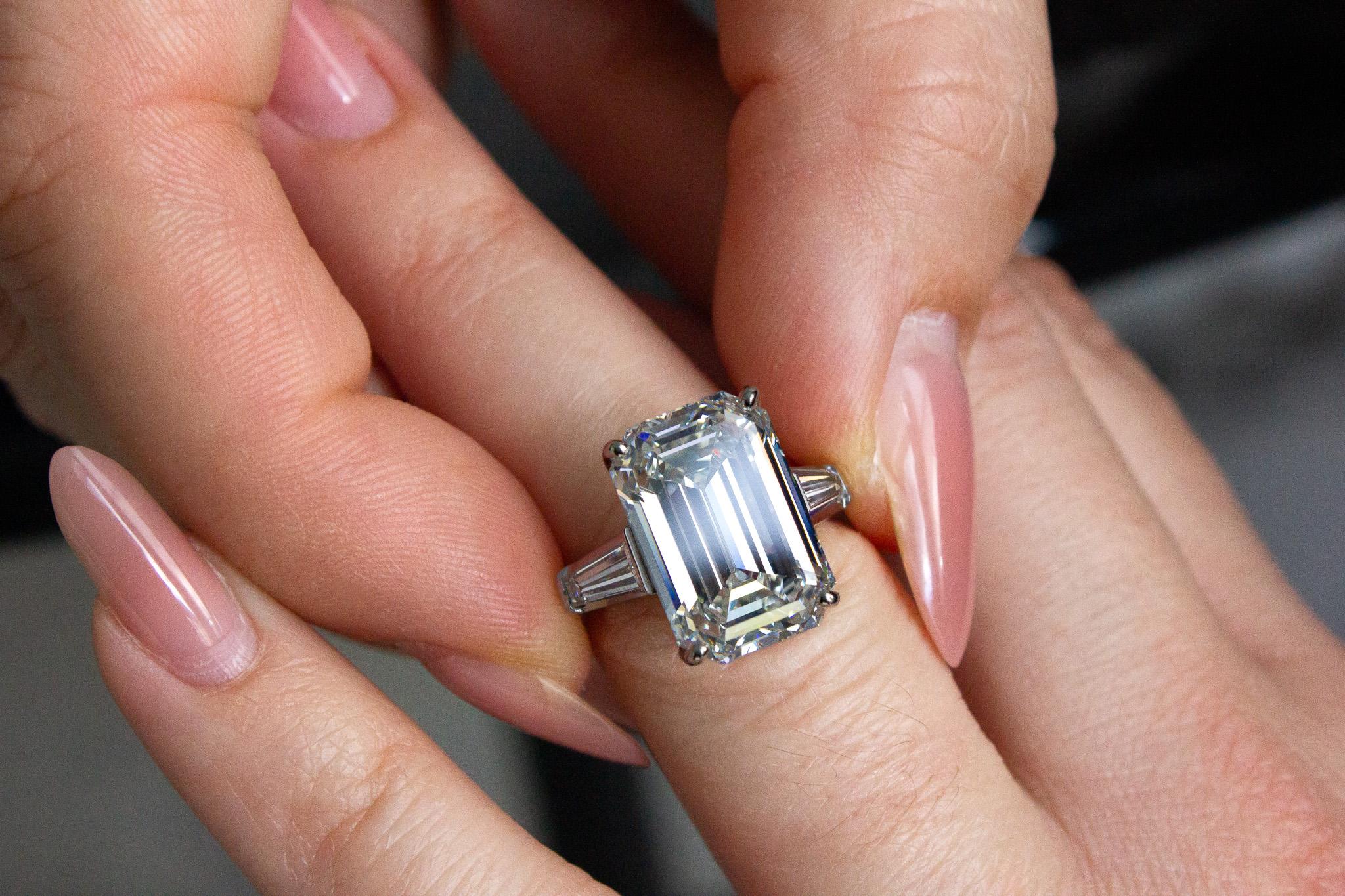 Make a bold statement with this GIA Certified 10.22 Carat Emerald Cut Diamond Three-Stone Ring. At the center of this exceptional piece is a breathtaking 10.22 carat emerald-cut diamond, GIA certified with J color and VS1 clarity, offering