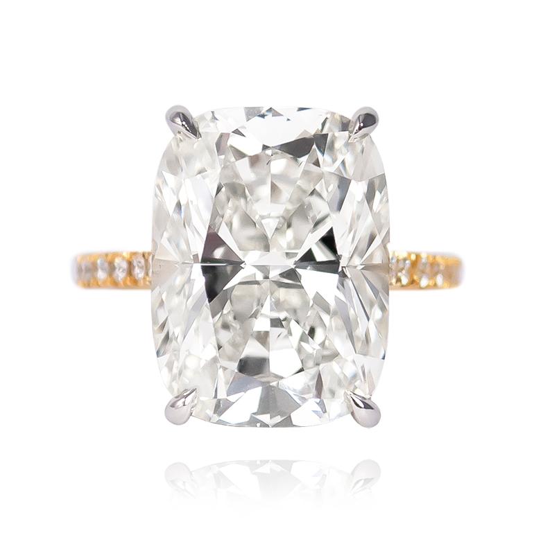 This scintillating stunner is fresh from the J. Birnbach workshop! Featuring a 10.41 ct Cushion Brilliant cut diamond of K color and SI1 clarity, this stone is set in a handmade platinum and 18K yellow gold pavé ring with 54 Brilliant Rounds = 0.49