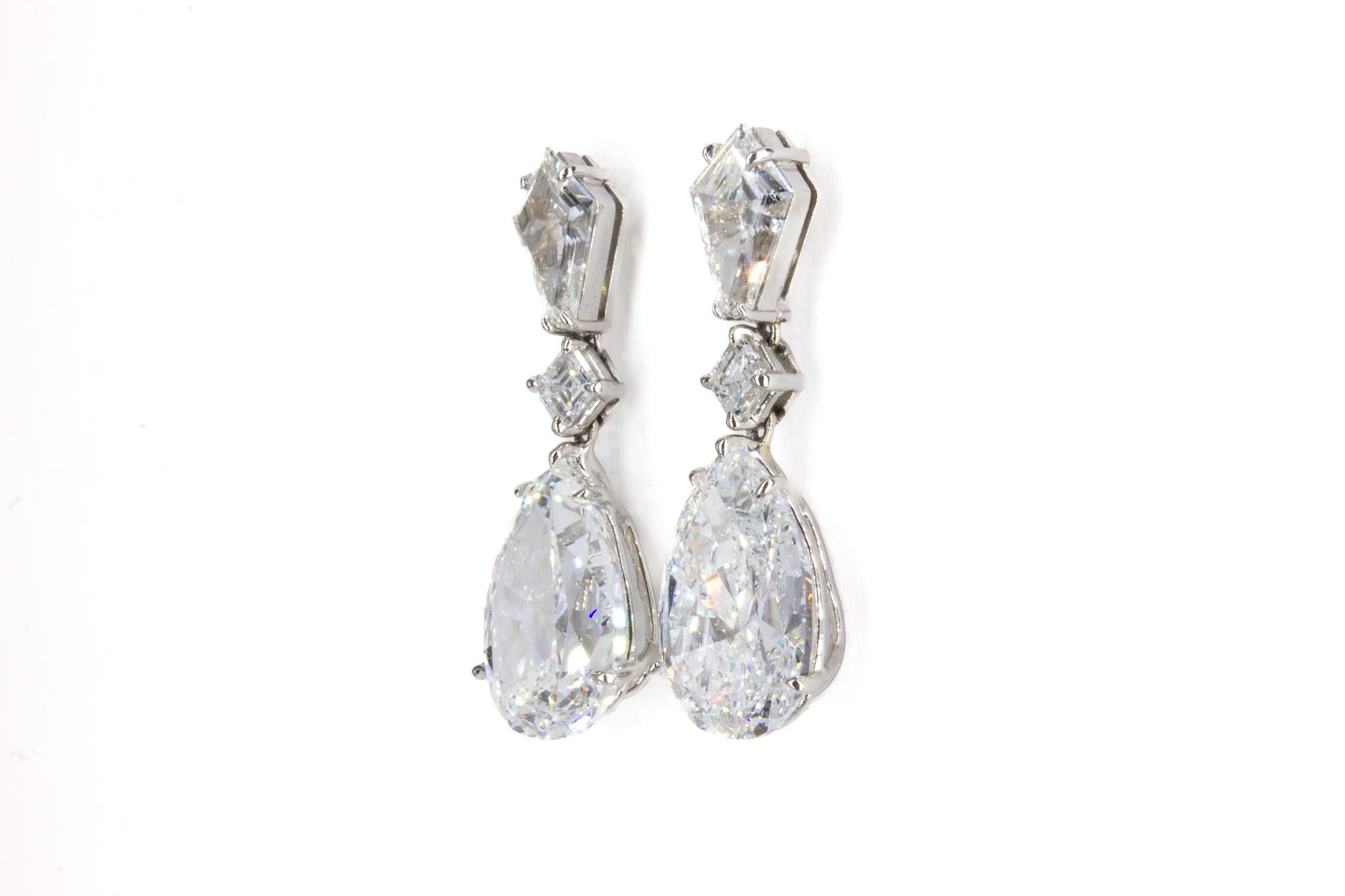 A breathtaking blend of elegance and brilliance, these GIA Certified 11.43 Carat Total Pear and Kite Diamond Drop Earrings are a true masterpiece of fine craftsmanship. At the heart of these exquisite earrings are two GIA certified pear-shaped