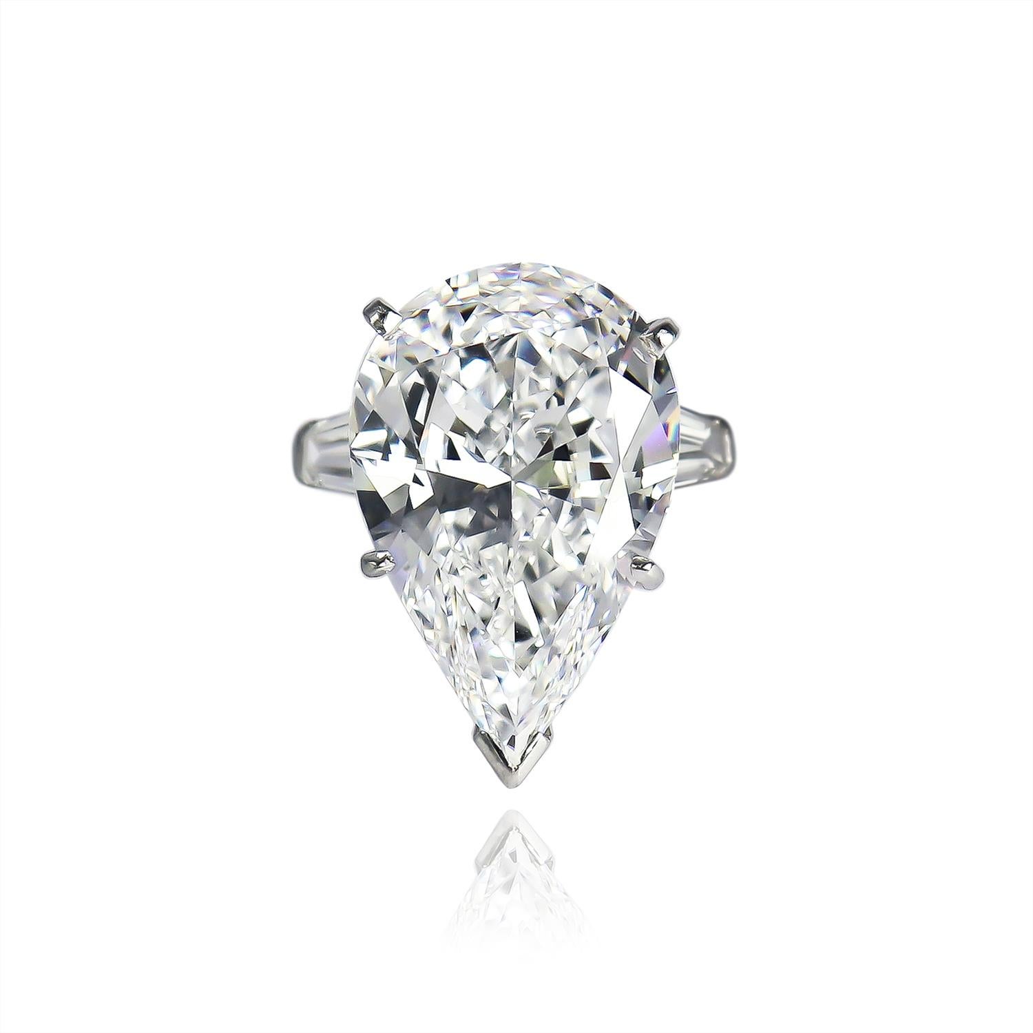 This exquisite piece from the J. Birnbach vault features a 12.19 carat pear brilliant cut diamond of D color and VVS1 clarity with no fluorescence. Beautifully outlined with a scintillating faceting pattern, the diamond is set in a a handmade,