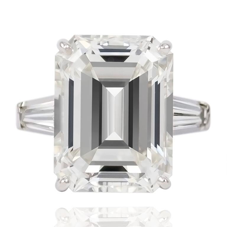 This incredible 12.20 ct Emerald cut from the vaults of J. Birnbach is for the true jewelry aficionado... GIA certified, this diamond is of J color and VS1 clarity flanked by a pair of tapered baguette = 1.34 ctw. Set in a platinum mounting, this is