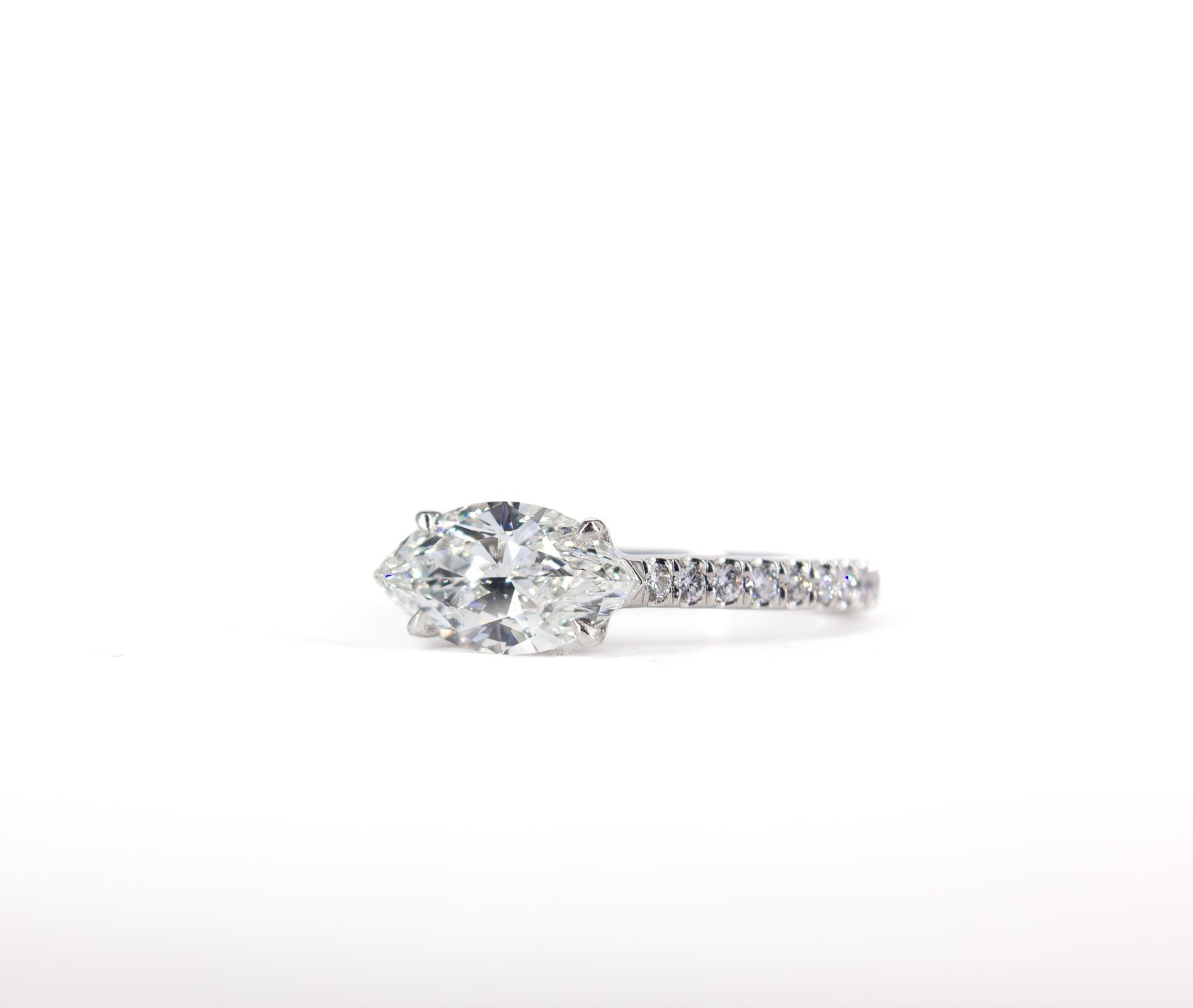 Discover timeless elegance with this captivating platinum ring. The centerpiece is a 1.52 carat marquise-cut diamond, certified by GIA with a stunning H color and I1 clarity, making it a remarkable focal point of this exquisite design.

Framing the