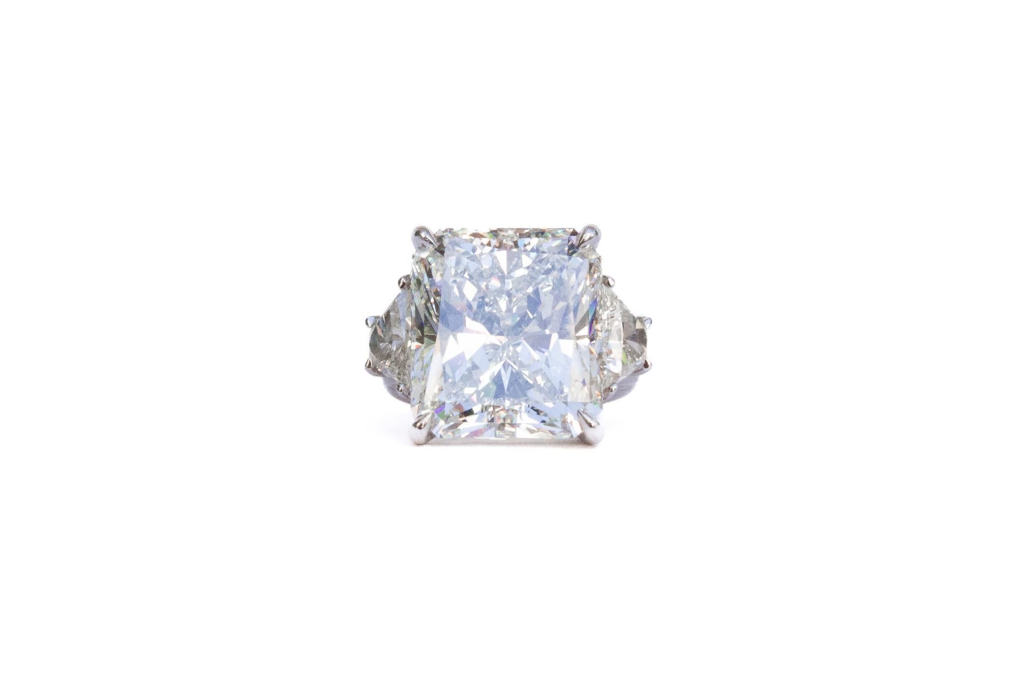 J. Birnbach workshop presents an incredible GIA certified 15.25 carat radiant cut diamond ring, of H color and VS2 clarity as described by GIA grading report #5182341217. 

Set in platinum, this handmade three-stone ring features matched, trapezoid