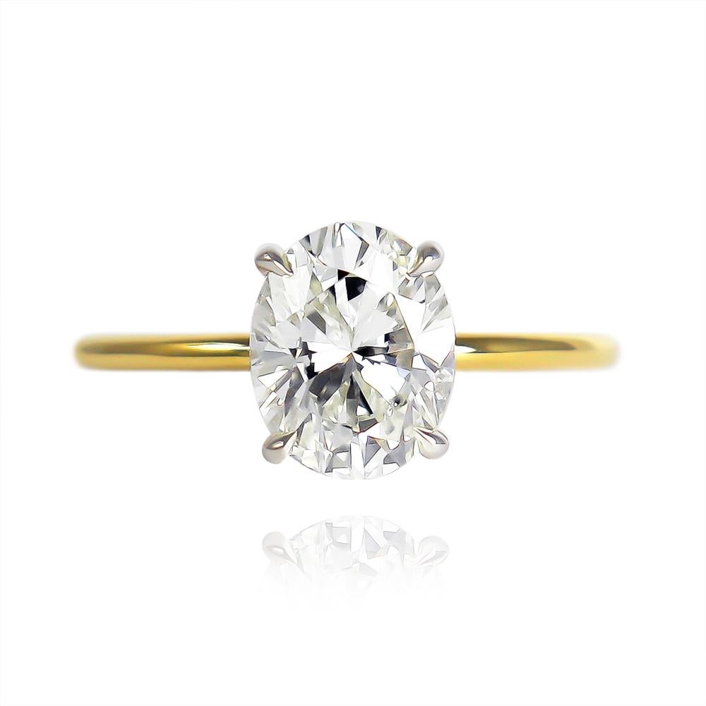 This elegant ring fresh from the J. Birnbach workshop features a GIA certified 1.73 carat oval brilliant cut diamond of M color and SI1 clarity... Beautifully faceted with a charming outline, this diamond is incredibly scintillating and 100%