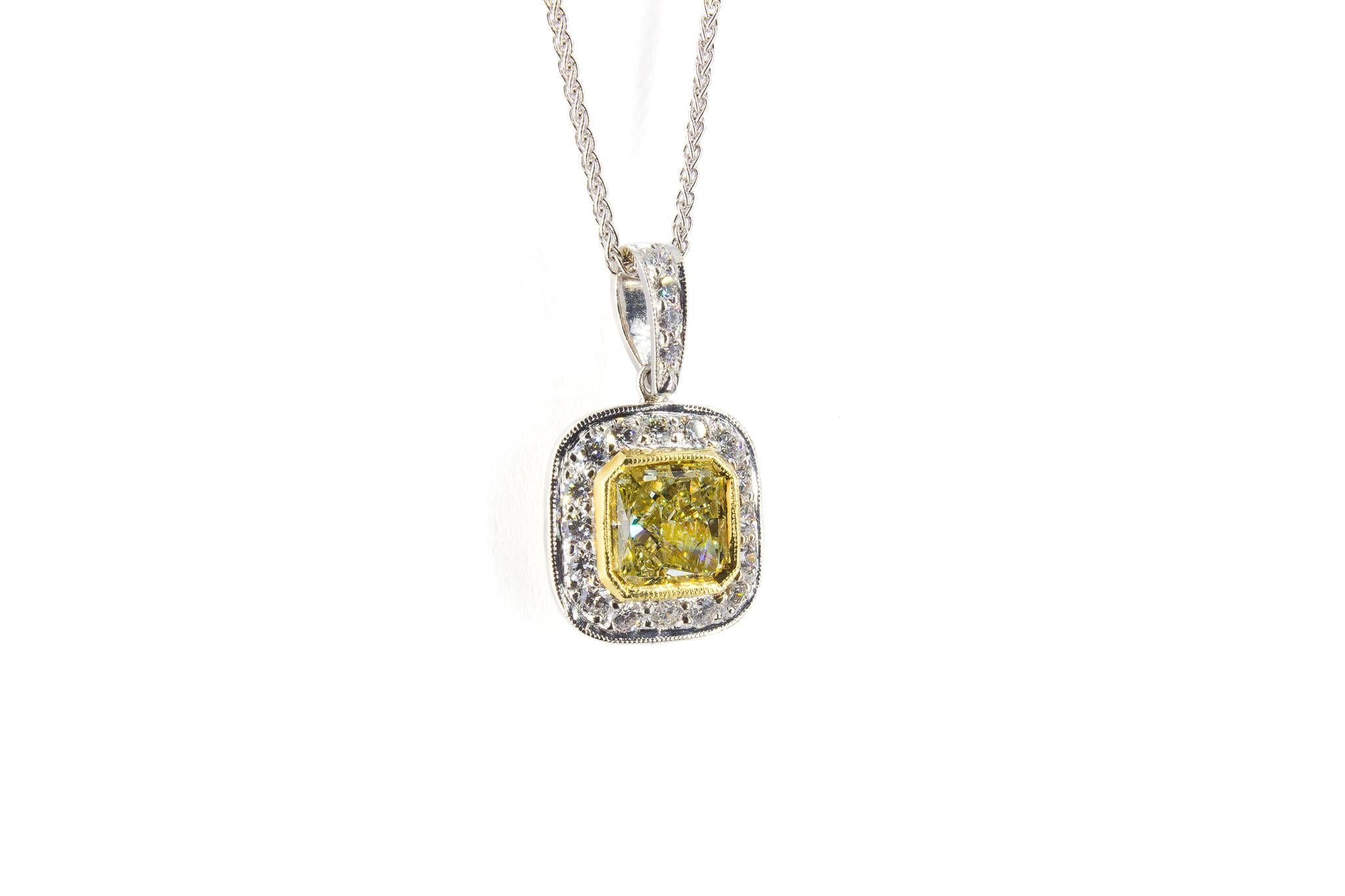 Celebrate radiant beauty with this elegant 18K two-tone diamond pendant. At its center, a captivating 1.78 carat radiant-cut fancy light yellow diamond, certified by GIA and graded VS1 clarity, exudes brilliance and sophistication.

The vibrant