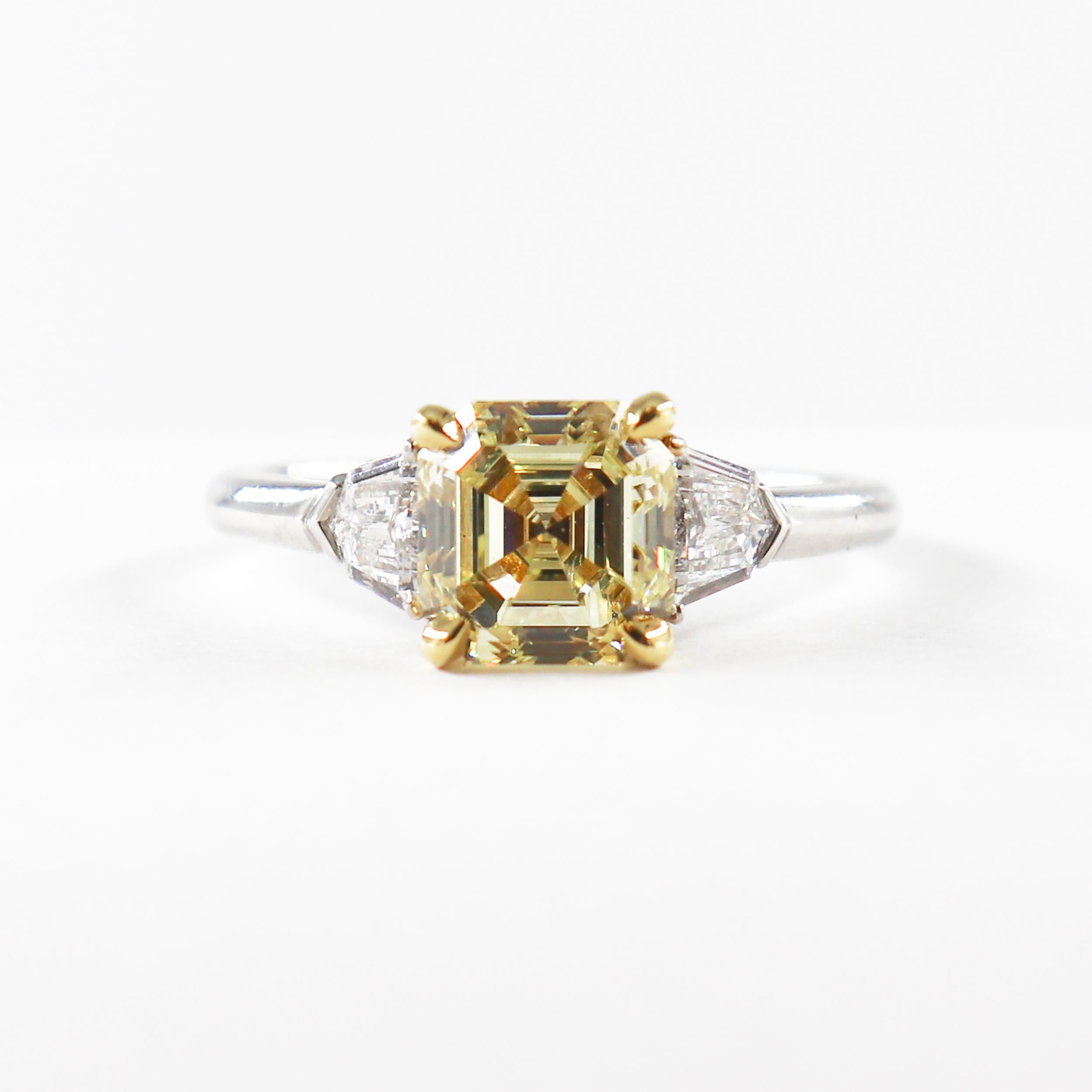 This exquisite piece by J. Birnbach combines classic style with a pop of color. The ring features a 1.94 carat GIA certified Fancy Yellow Asscher cut diamond, with a beautifully saturated color and lively sparkle. The yellow Asscher cut is set in