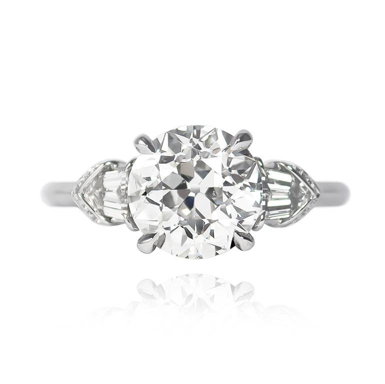 Sweet beyond description, this handmade, platinum ring features a 2.30 ct Old European cut diamond of I color and SI2 clarity. Flanked by a pair of tapered bullet side stones = 0.30 ctw and pavé details = 0.08 ctw, this piece is bursting with