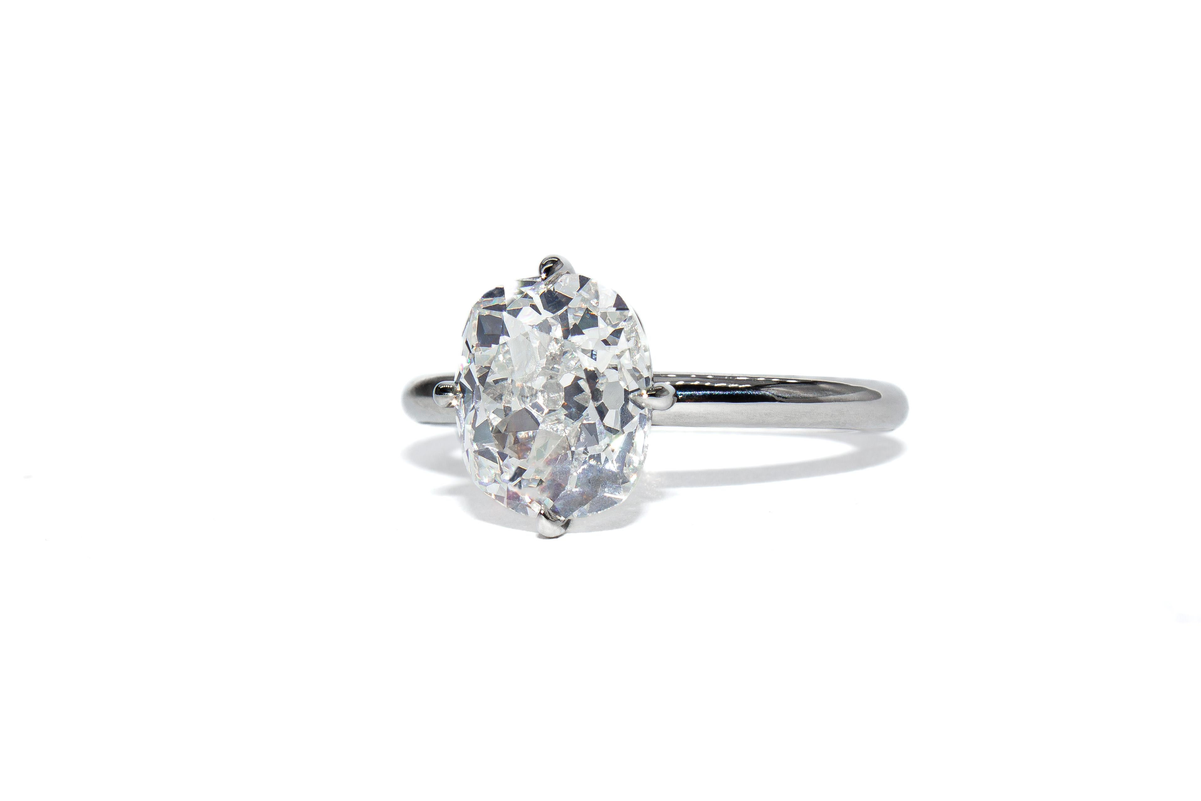 Questo sorprendente anello solitario in platino presenta un diamante certificato di 2,75 carati con taglio brillante di vecchia miniera di eccezionale colore E e purezza VS2 (GIA). Con le sue sfaccettature antiche e il contorno a cuscino