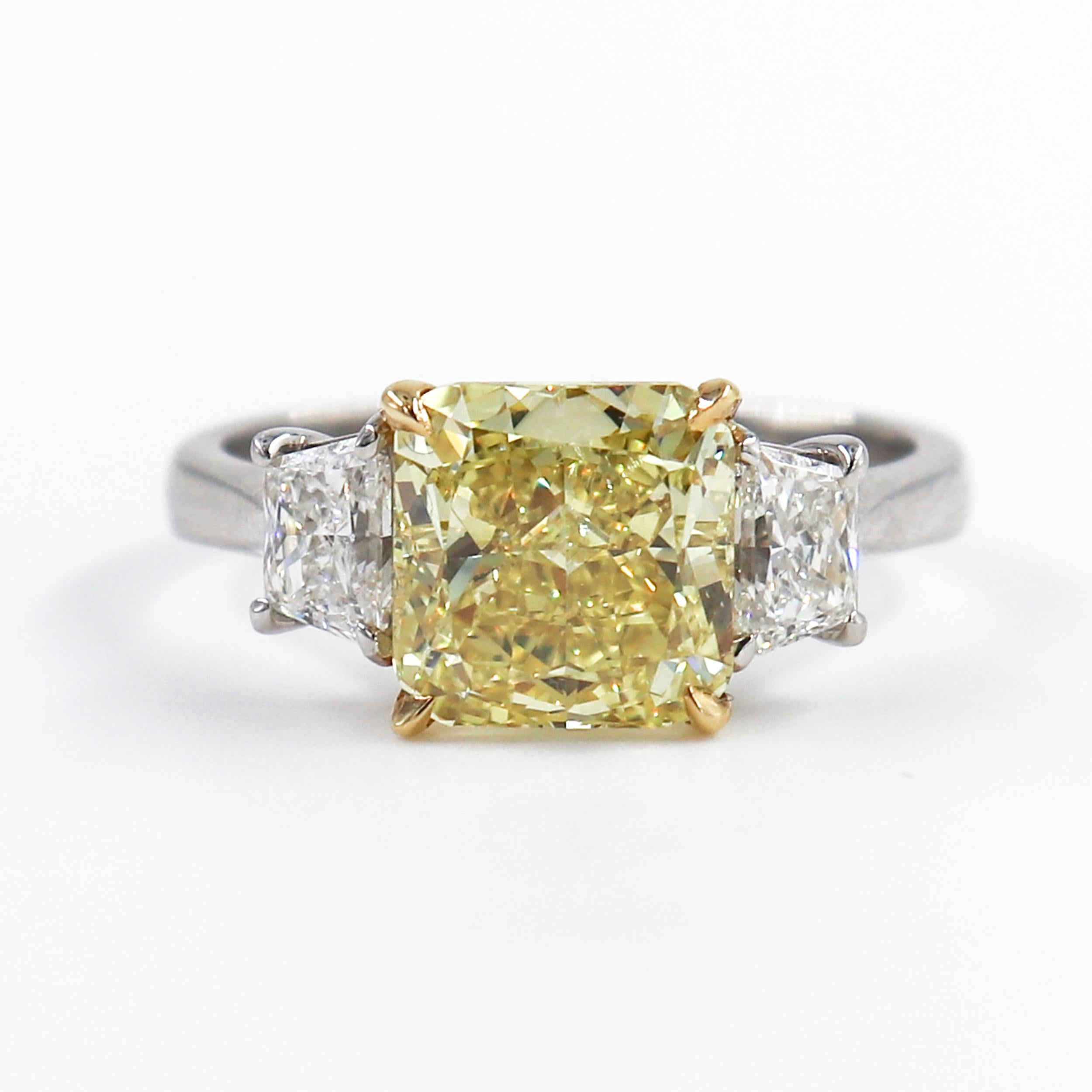 This stunning ring by J. Birnbach features an exceptionally colorful 2.86 carat radiant cut yellow diamond. The diamond's color has been graded Fancy Vivid by GIA, and it is rare to find a diamond with such a beautifully rich and saturated color.