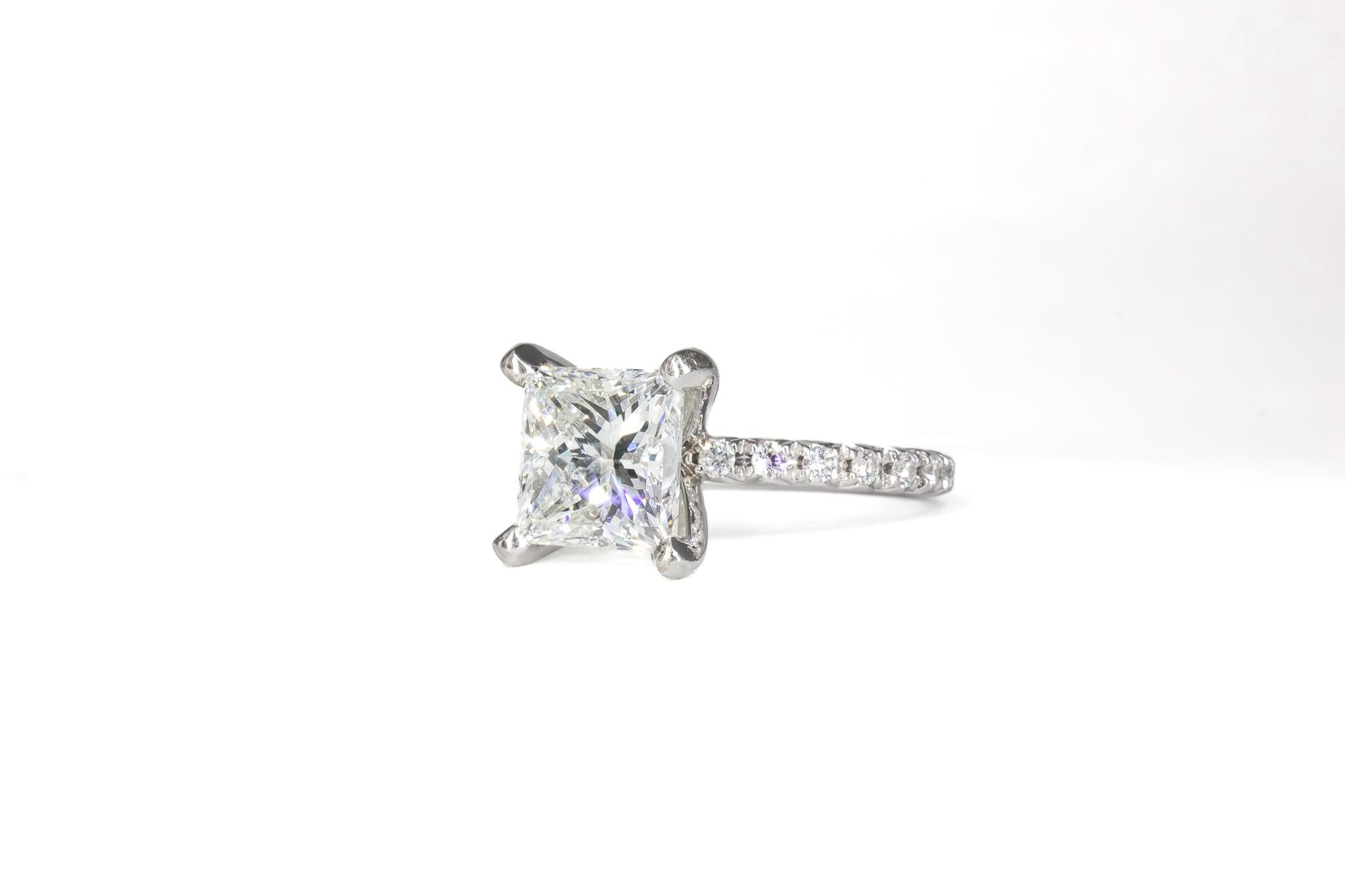 This exquisite platinum pavé ring showcases a breathtaking 2.92-carat princess-cut diamond, certified by GIA as J color with VS2 clarity. The diamond’s sharp angles and brilliant facets create a mesmerizing display of light, making it a stunning