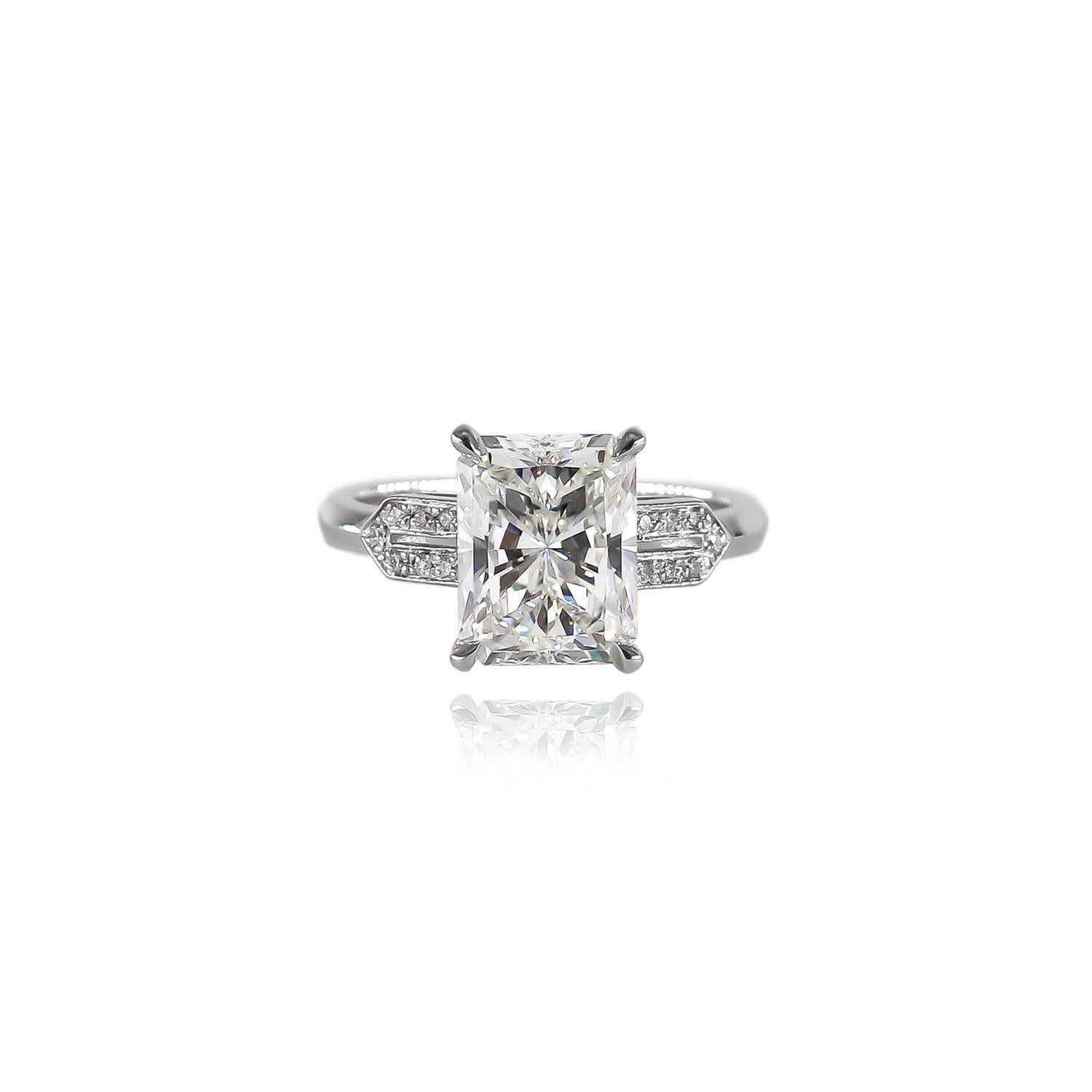 This exquisite new ring from the J. Birnbach workshop features a certified 3.01 carat radiant cut diamond of I color and VS1 clarity as described by GIA grading #2357921677. Set in a platinum ring with Art Deco inspired motifs, this geometric