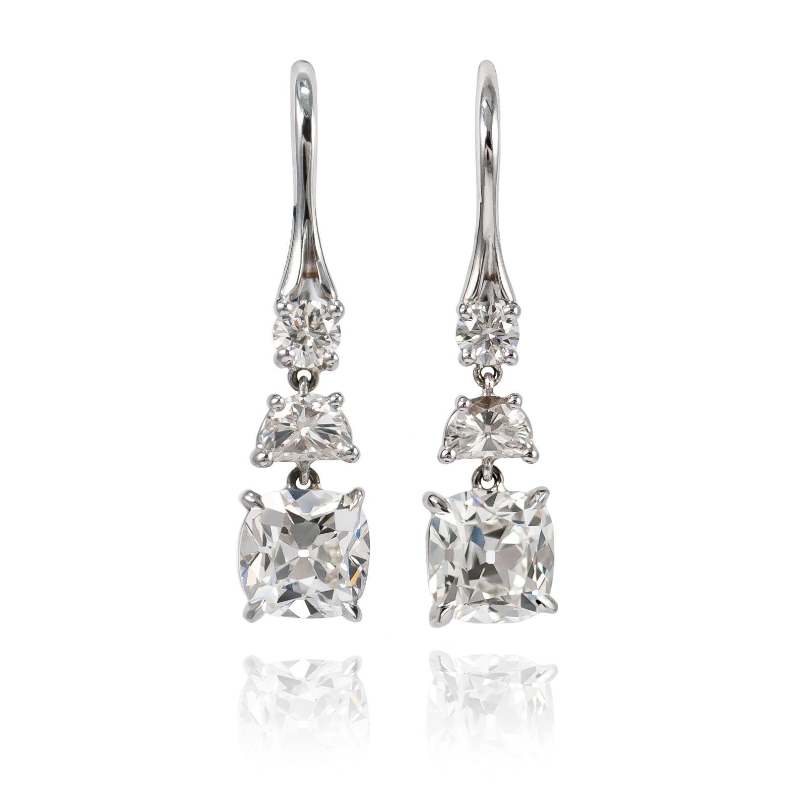 These fantastic drop earrings will become an everyday staple of your jewelry collection! Handmade in 18K white gold, these drops feature a pair of Brilliant Rounds = 0.78 ctw, Half Moons = 0.48 ctw, and GIA certified 1 carat Cushion Brilliant cut
