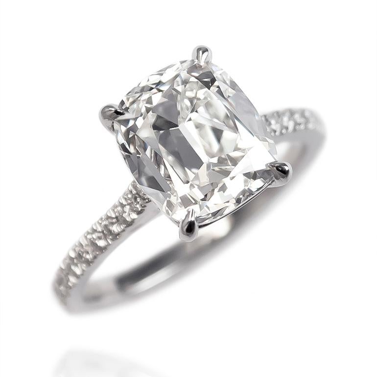 This charming and sweet ring features a 3.57 carat Cushion Brilliant cut diamond of H color and VS1 clarity. Set in a handmade, platinum mounting with pavé details = 0.24 ctw, this ring is the perfect pairing of antique diamond cutting and
