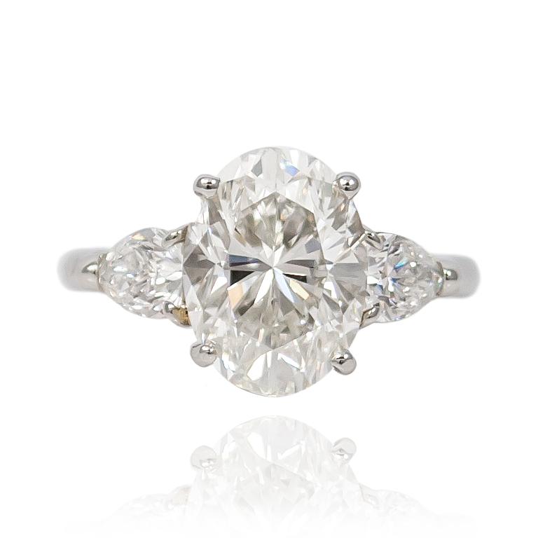 This incredible three stone ring from the vaults of J. Birnbach features a 3.58 ct Oval diamond of H color and VS1 clarity. Set in a platinum, handmade mounting with two modified  pear shape diamonds = 0.80 ctw. 

Purchase includes original GIA