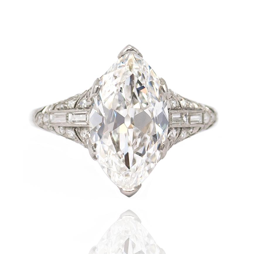 This one-of-a-kind ring features a breathtaking 3.78 ct Antique Marquise diamond set in a handmade platinum ring mounting. With four straight baguettes and brilliant round pavé enhanced with milgrain details, this ring celebrates the incredible