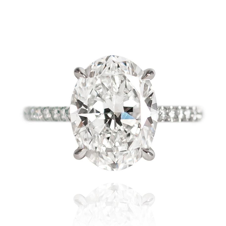This contemporary beauty features a 4.01 carat Oval of H color and VS1 clarity... Set in a platinum ring with pavé details = 0.21 ctw, this ring is made so that other rings be worn flush with no gapping... What's not to love? 

Purchase includes