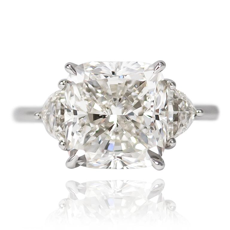 This piece is hot off the bench from the J. Birnbach workshop! This lovely, platinum, three stone ring features a 4.02 carat Cushion cut diamond of I color and SI1 clarity... Scintillating and large looking, this center is set with a pair of shield