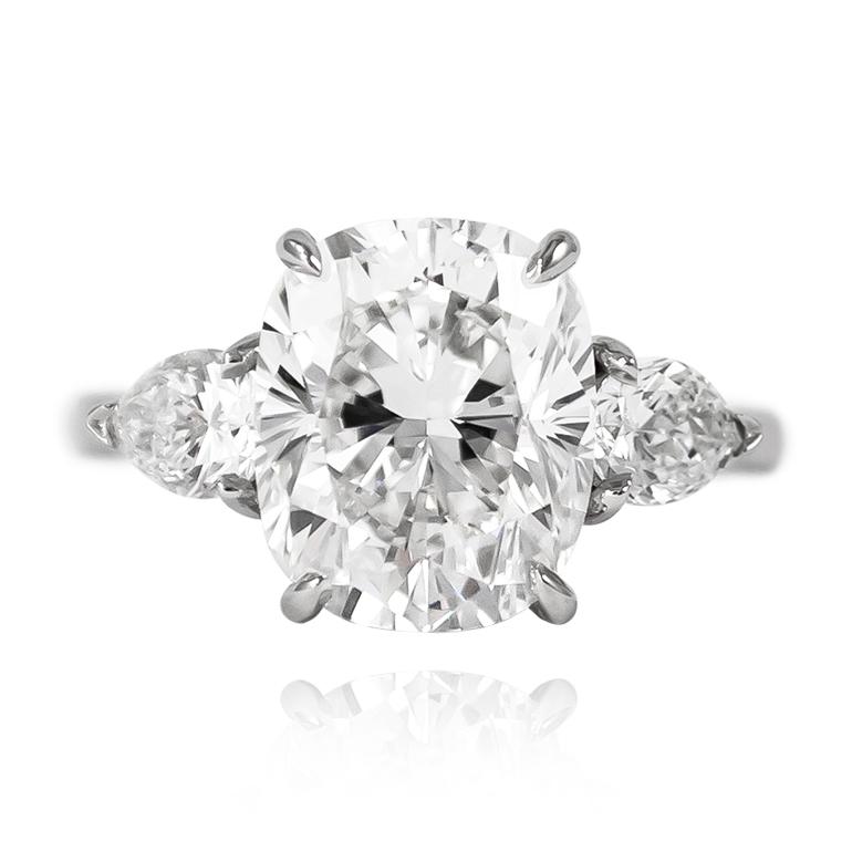 This sweet and charming ring is fresh from the J. Birnbach workshop! Featuring a magnificent 4.37 ct Cushion Brilliant cut diamond of E color and VS1 clarity, set in a handmade, platinum ring mounting with a pair of pear shape side stones = 0.50