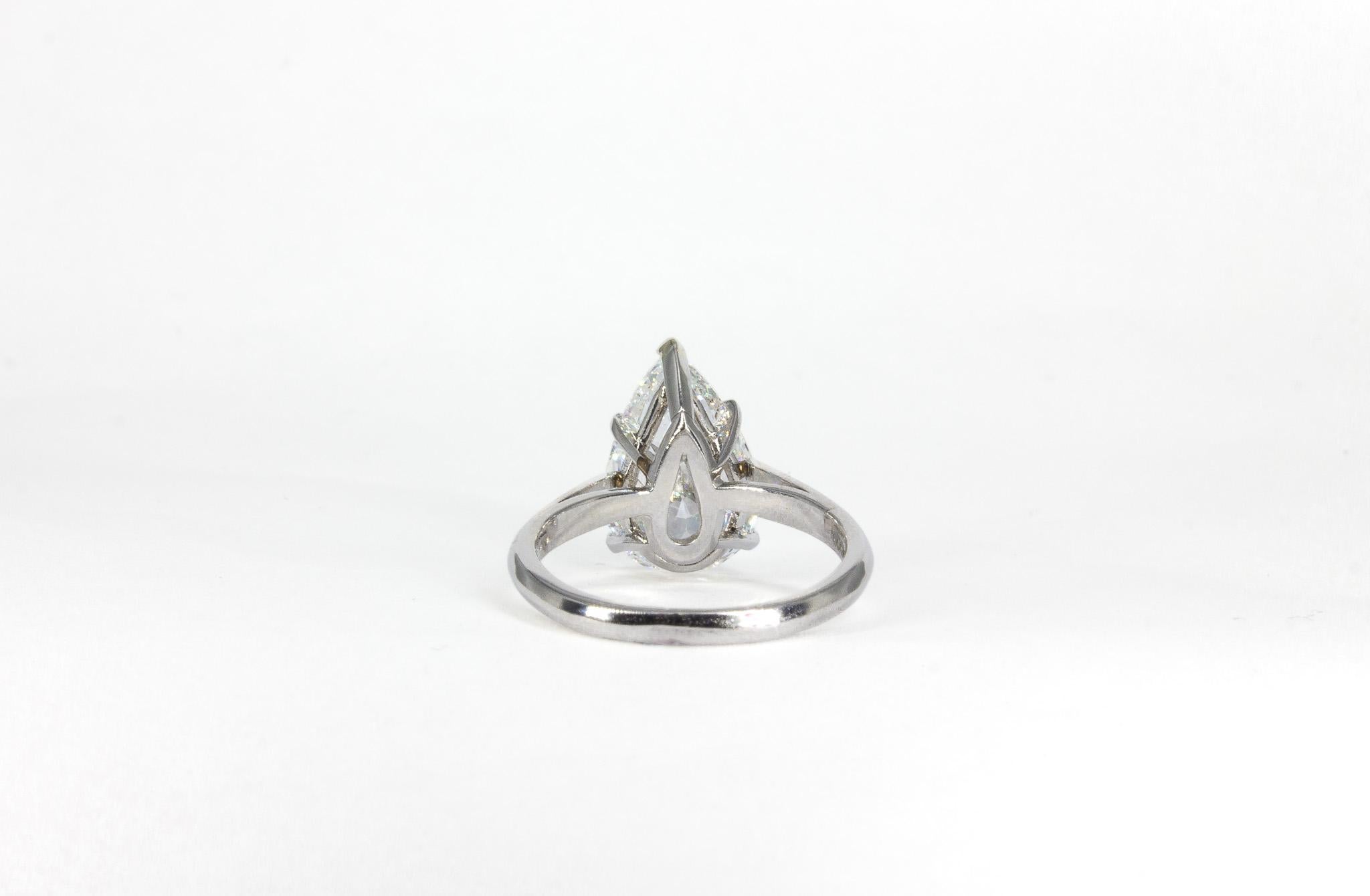 Timeless and elegant, this GIA Certified 4.41 Carat Pear Shape Diamond Solitaire Ring is a stunning statement of refined beauty. The centerpiece of this exquisite ring is a breathtaking 4.41 carat pear-shaped diamond, GIA certified with G color and