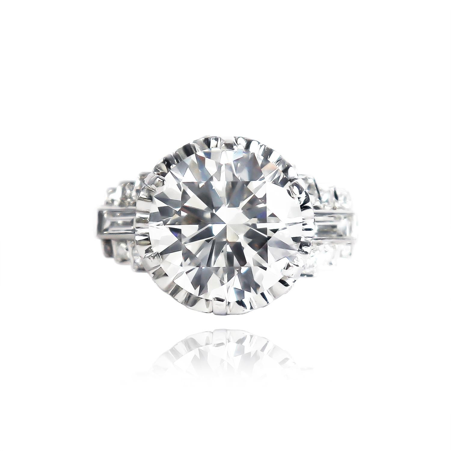This incredible, recently-restored, vintage piece from the J. Birnbach collection features a GIA certified 4.51 carat round brilliant diamond of I color and SI1 clarity. Set in a phenomenal vintage mounting with straight baguettes and assorted