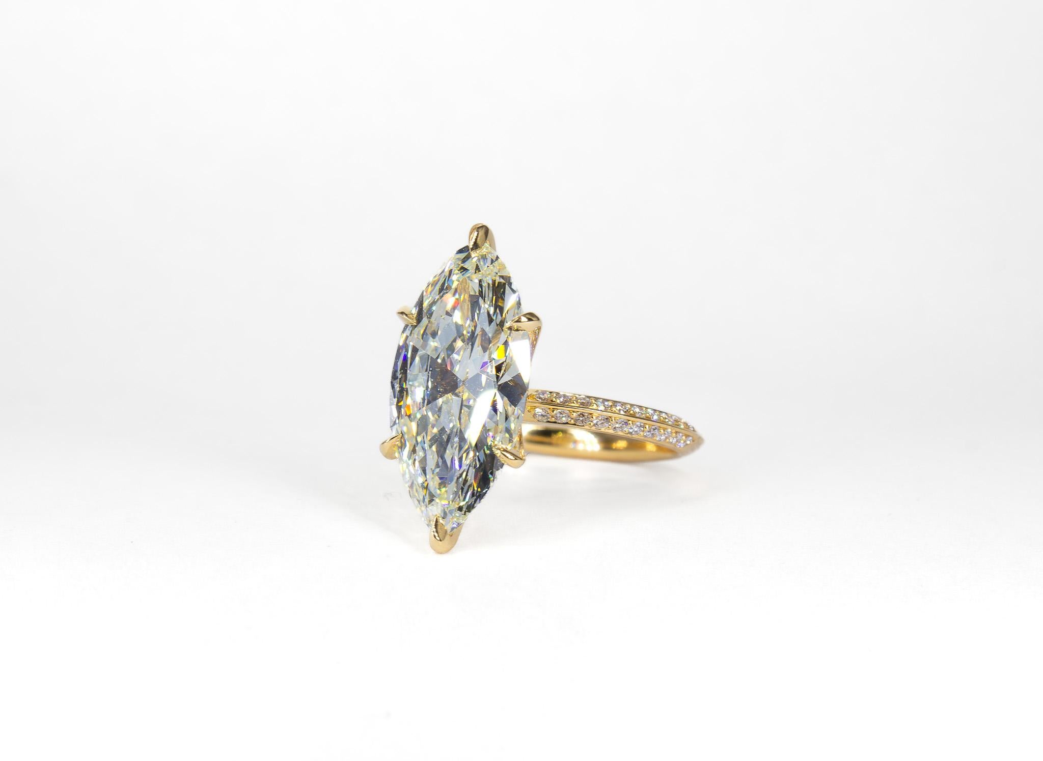 Elevate your jewelry collection with this striking 18K Yellow Gold Solitaire Ring. Featuring a magnificent GIA-certified 4.57 carat marquise-cut diamond with an impressive L color and VS1 clarity, this ring is the epitome of timeless elegance. The