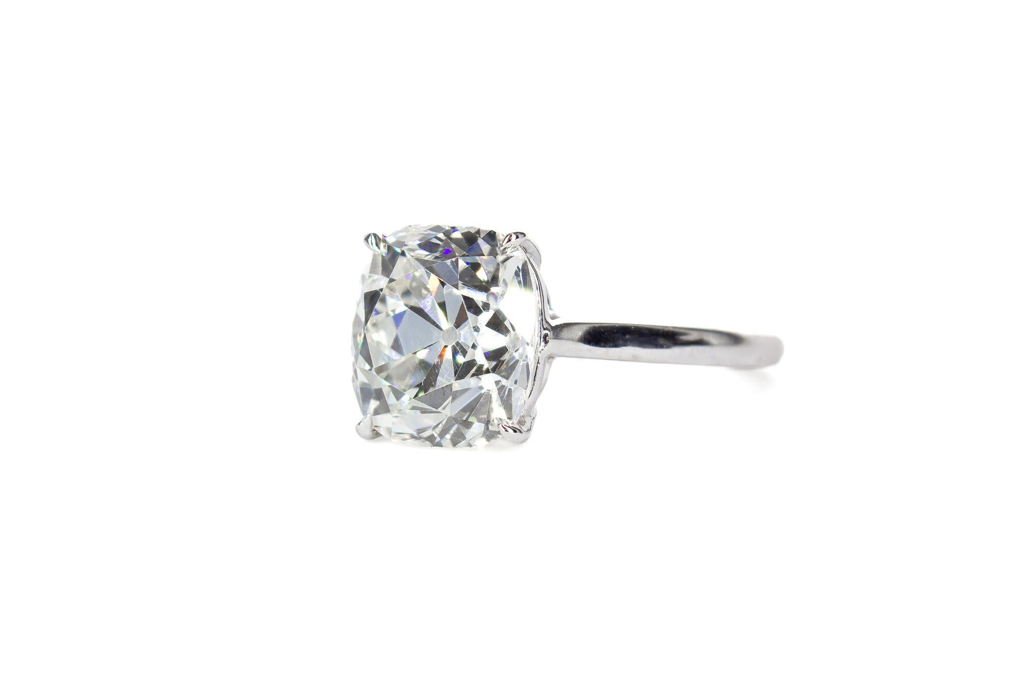 This exquisite platinum solitaire ring is a masterful display of craftsmanship, blending timeless elegance with refined design. The centerpiece is a stunning 4.58 carat Old Mine Cut diamond, GIA-certified K color and SI1 clarity, radiating vintage