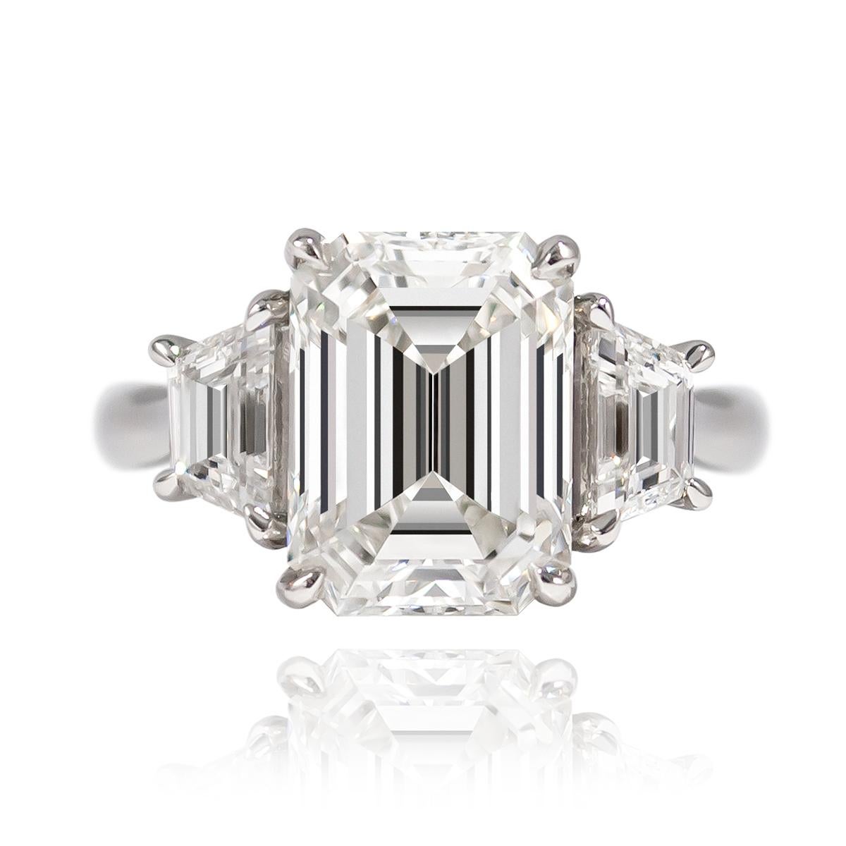 Beautiful and timeless, this J. Birnbach original features a 5.02 ct Emerald cut of G color and VVS1 clarity. Set in a handmade, platinum ring with diamond trap side stones = 0.90 ctw, this piece in an incredibly large look that is sure to be the