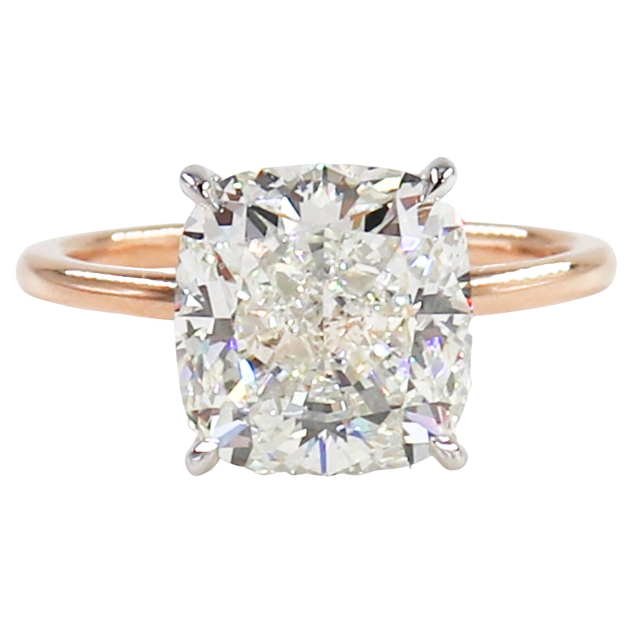 Simple, sleek and sparkly, this elegant solitaire is a timeless choice for an engagement ring! This piece features a 5.03 carat cushion cut diamond certified by GIA to be J color and VS2 clarity. This beautiful, slightly elongated shape is very