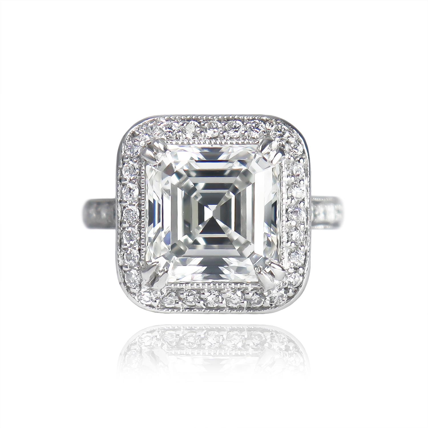 This beautiful, recently  purveyed ring features a GIA certified 5.20 carat Asscher cut diamond of H color and VS2 clarity as described by GIA grading report #15040716. Set in a platinum, bright-cut pavé ring with milgrain details, this piece is a