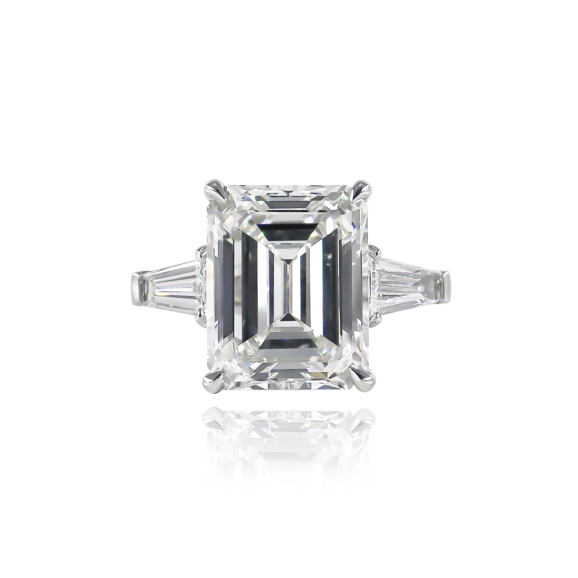 This exceptional, new ring fresh from the J. Birnbach workshop features of beautifully faceted 5.49 carat emerald cut diamond of H color and SI2 clarity as described by GIA grading report #2225076856. The stone is set in a platinum, three-stone ring