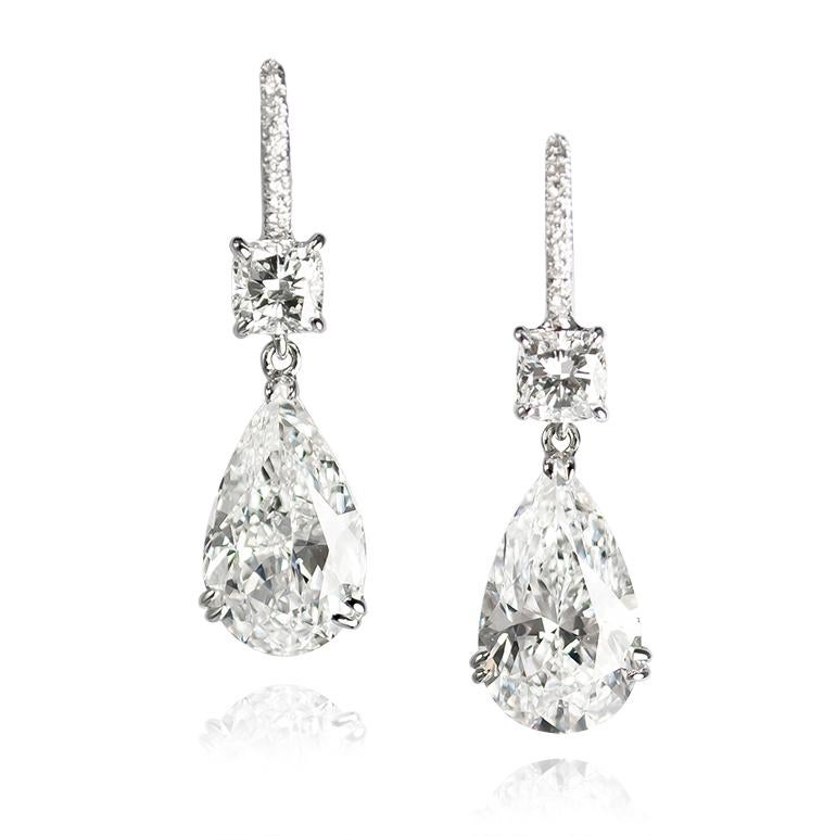 This scintillating pair of 18K white gold earrings are set with two cushion-cut diamonds = 0.81 ctw and GIA certified pear shape diamonds = 6.09 ctw of D color and SI clarity . Suspended from diamond pavé leverbacks = 0.08 ctw, these drops catch the