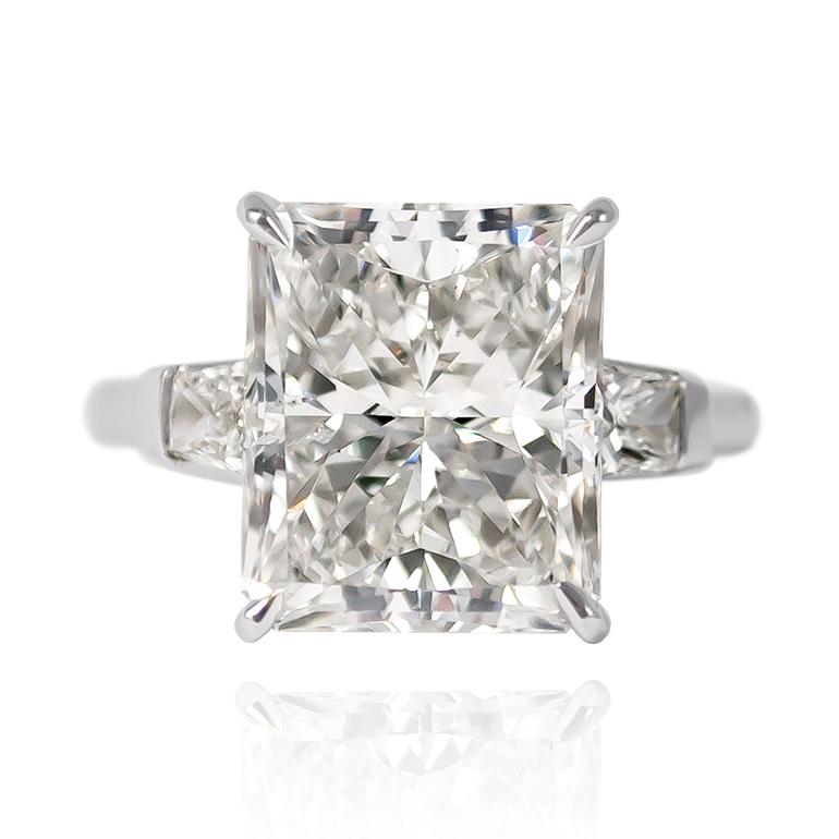 This scintillating sparkler features an 8.03 ct Radiant cut diamond of J color and SI2 clarity... Set in a handmade, platinum mounting with beautifully-matched, brilliant cut tapered baguette side stones = 0.75 ctw (approximately), this ring is