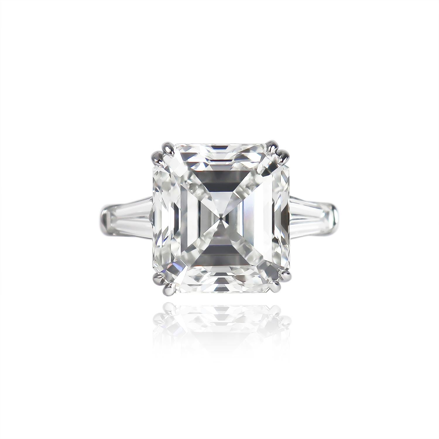 This classically designed ring from the J. Birnbach workshop features an 8.21 carat square, emerald cut diamond of G color and VS1 clarity with no fluorescence. Set in a handmade, platinum, three-stone ring with tapered baguette side stones = 0.75