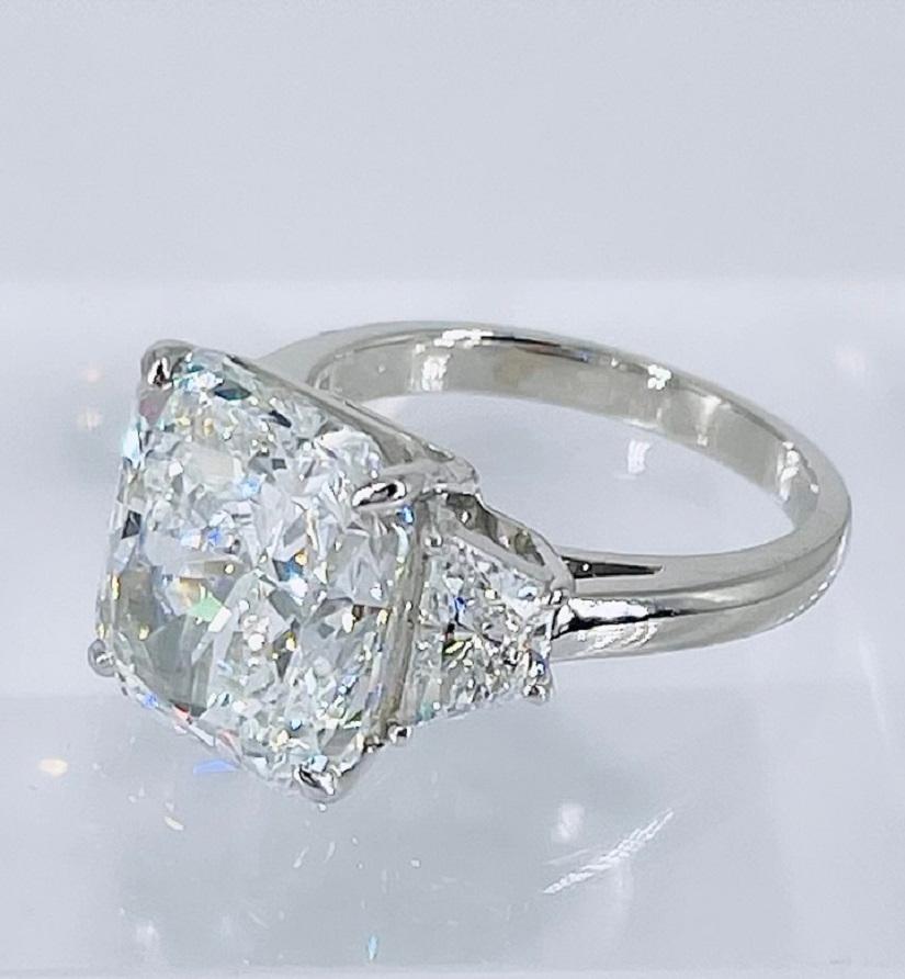 This gorgeous statement piece by J. Birnbach features a showstopping 8.29 carat radiant cut diamond. It is certified by GIA as E color, which is the second highest color grade and in the colorless range, and SI1 clarity. This magnificent stone is