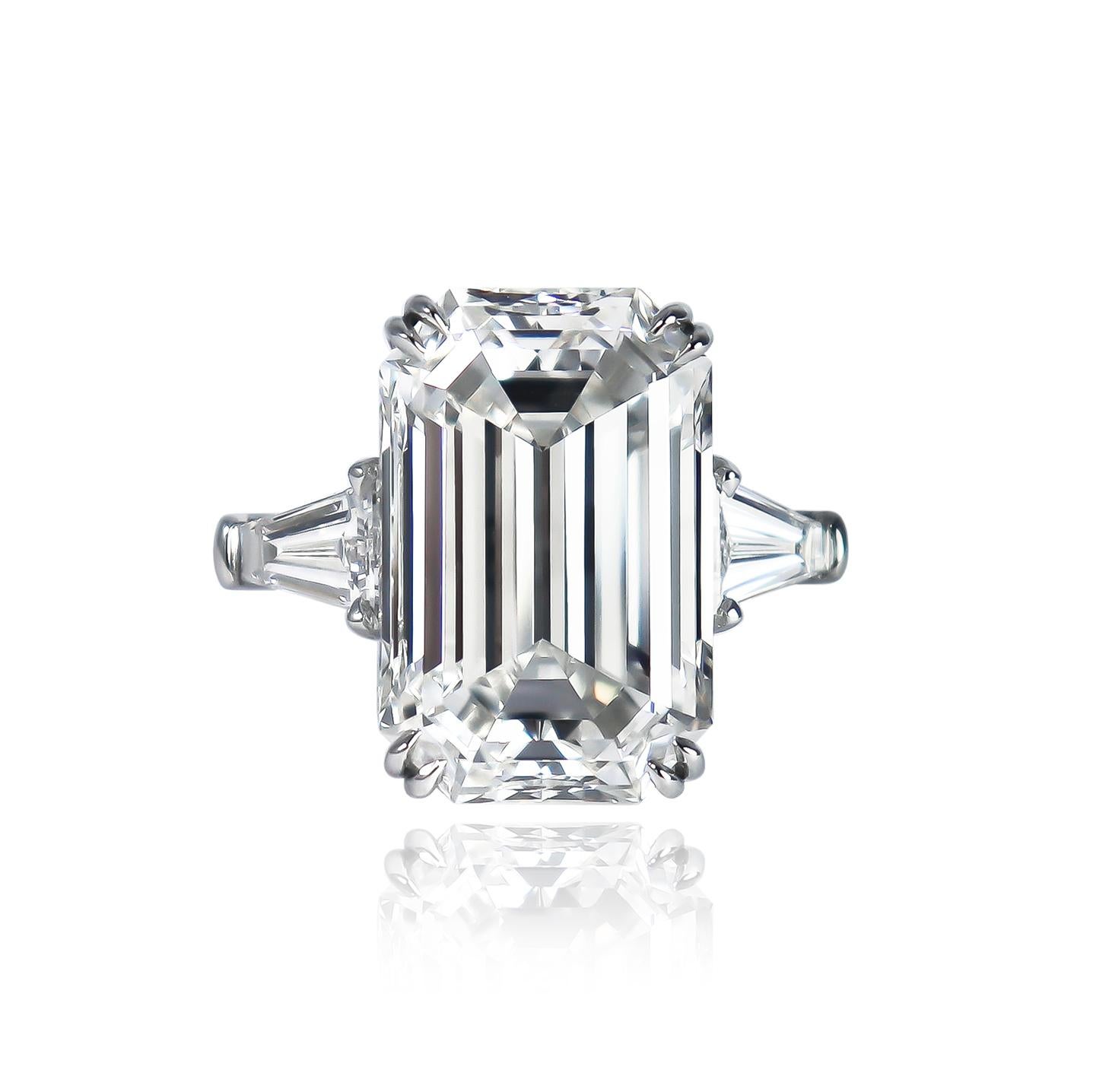 This ring fit for royalty is fresh from the J. Birnbach workshop! Featuring a GIA certified 9.23 carat emerald cut diamond of F color and VVS1 clarity, this center stone is thoughtfully set with a pair of beautifully tapered baguette side stones =