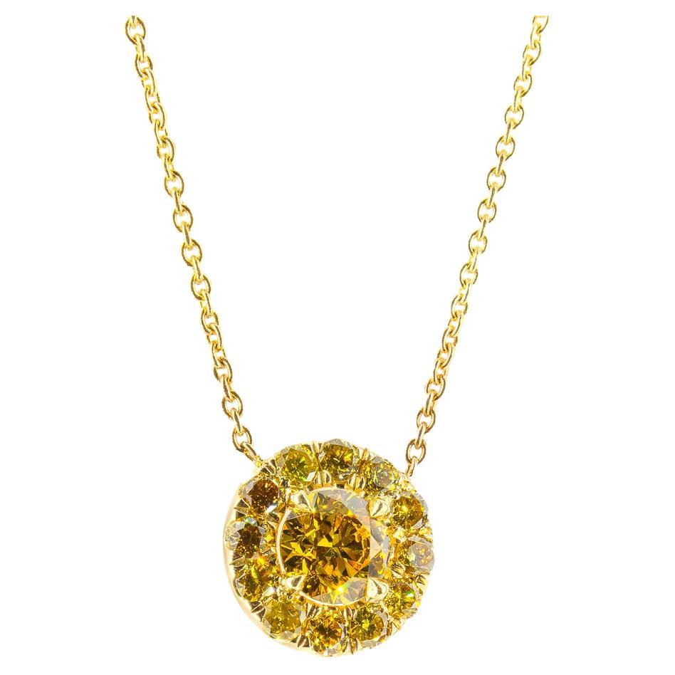 Illuminate your style with this breathtaking 18K yellow gold pendant necklace, a celebration of vibrant color and refined craftsmanship. At its heart lies a GIA-certified 0.56 carat round brilliant fancy vivid orangy yellow diamond, boasting VS2