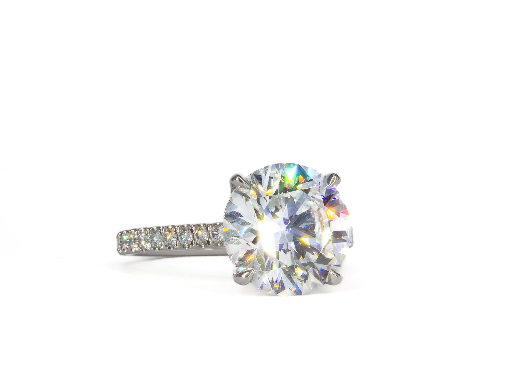 A timeless expression of brilliance, this GIA Certified 4.50 Carat Round Brilliant Diamond Ring is the epitome of classic elegance. The centerpiece of this exquisite ring is a dazzling 4.50 carat round brilliant diamond, GIA certified G color and