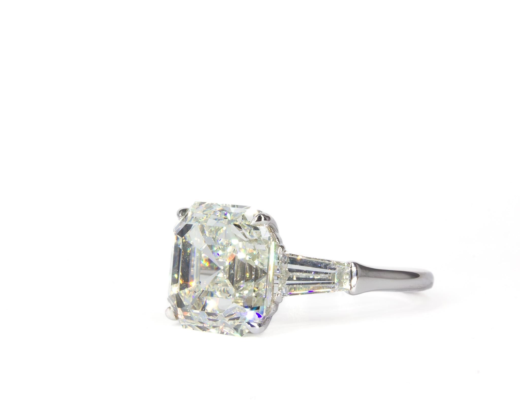 Classic and sophisticated, our J. Birnbach GIA Certified K VS2 7.00 Carat Asscher Cut Diamond Three-Stone Ring showcases timeless elegance with exceptional craftsmanship. At its center is a breathtaking 7.00 carat diamond, GIA certified with K color