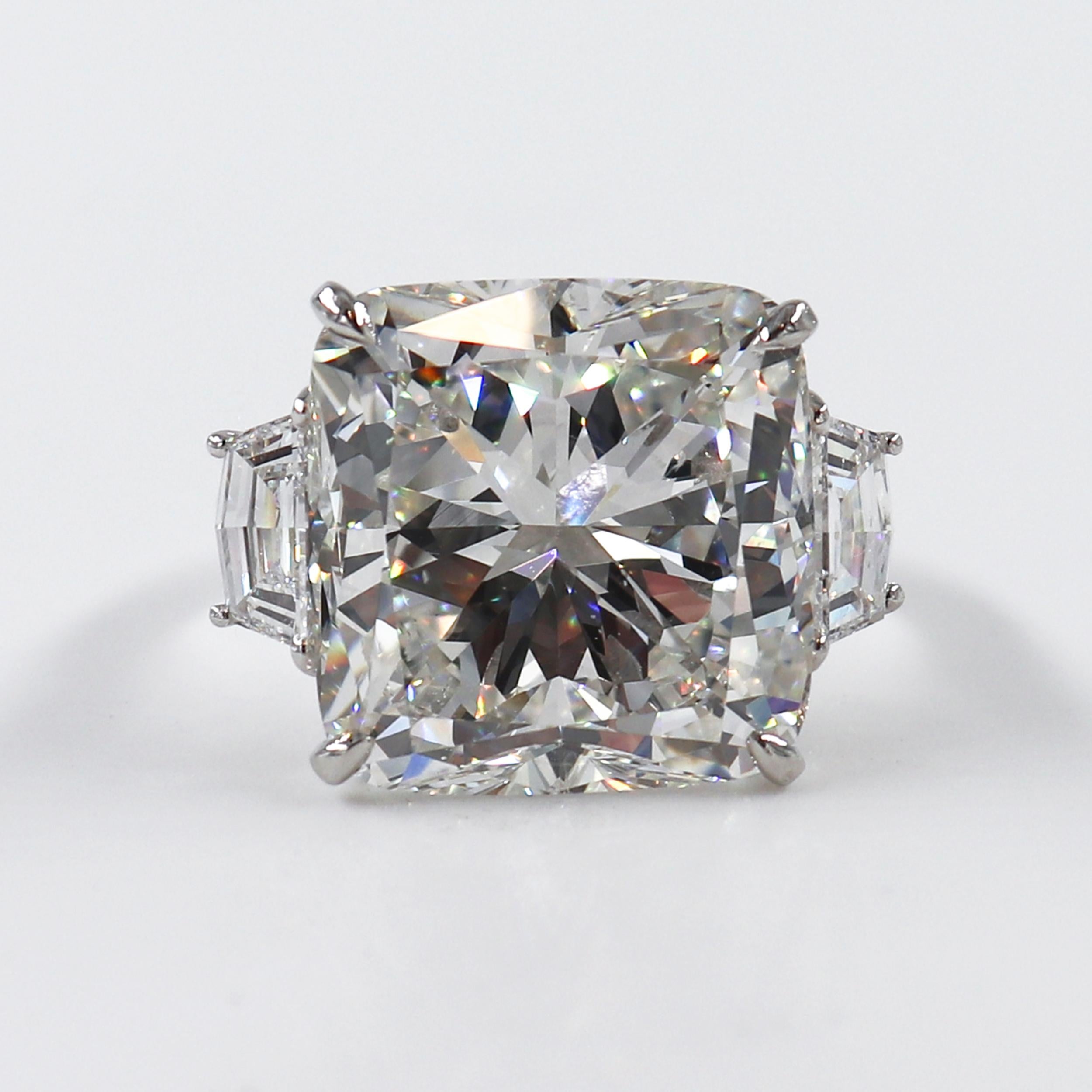 This J. Birnbach spectacular ring crafted in platinum features a 15.10-carat Cushion diamond with G color and SI1 clarity. The center diamond is accentuated by two epaulettes cut diamonds of approximately 0.90-carat each. 

This ring is a size US