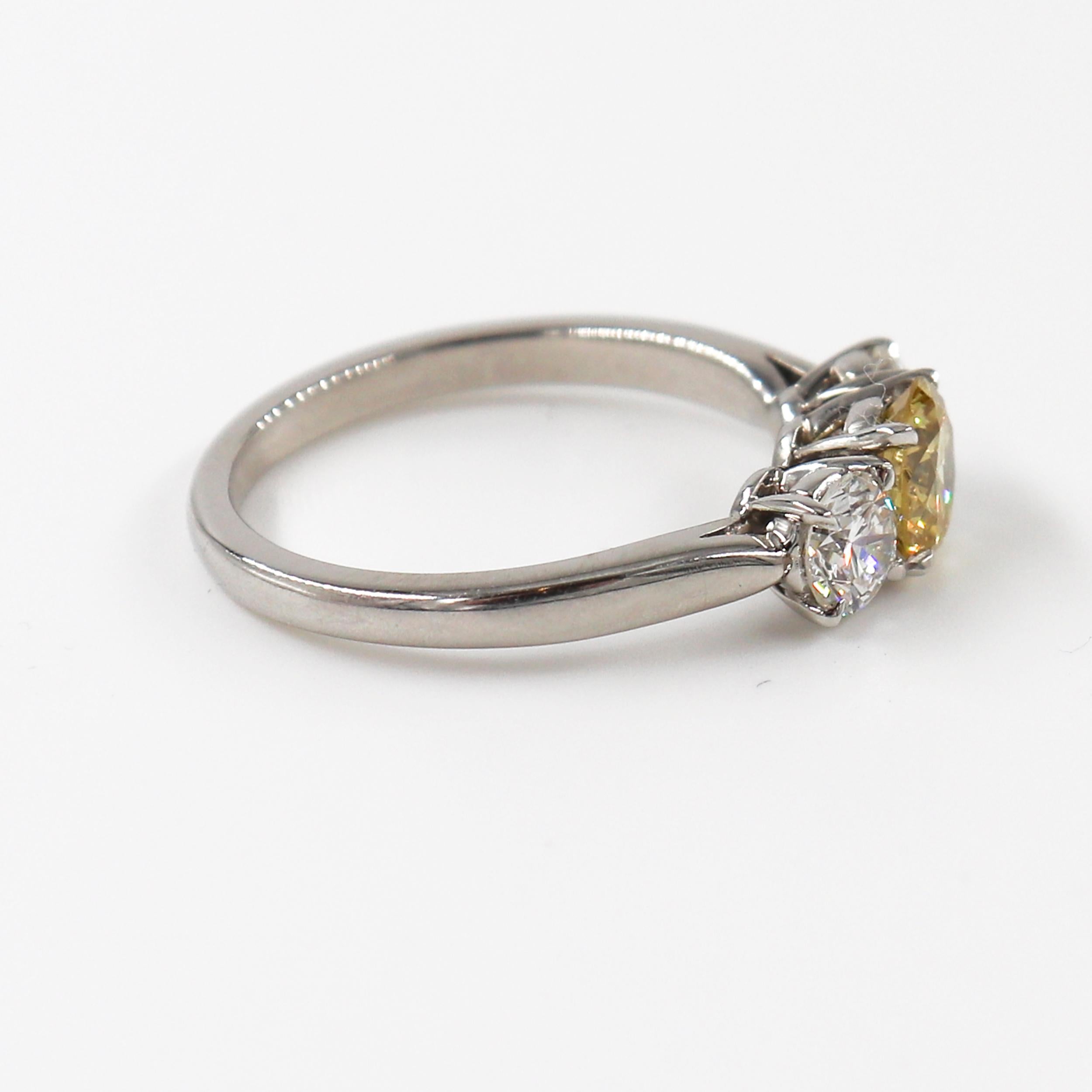 Round Cut J. Birnbach Fancy Intense 0.66 carat Yellow Round Diamond Three Stone Ring For Sale