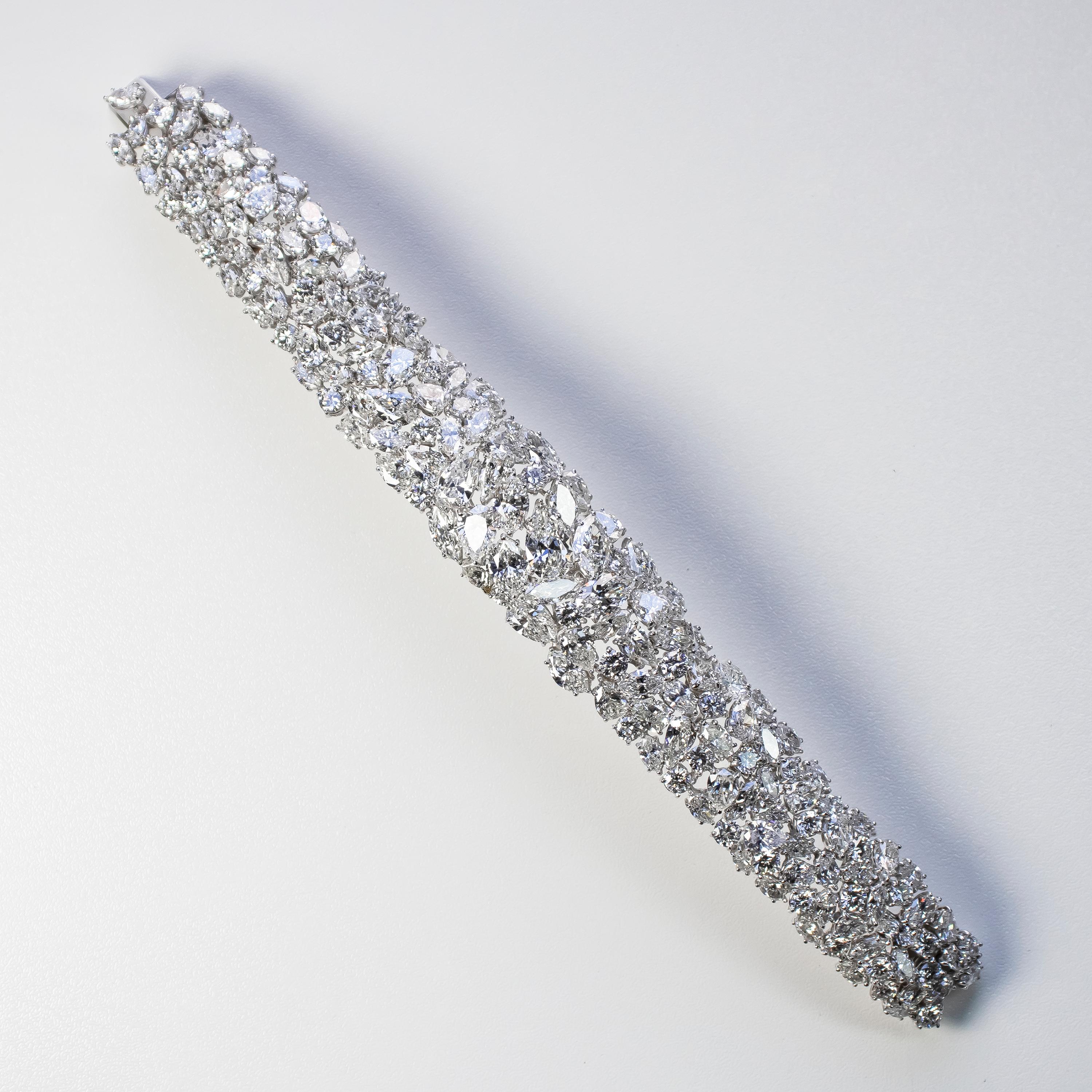 This exceptional, handmade, mesh style bracelet by the house of J. Birnbach features a spectacular array of beautifully matched, natural, fancy and round brilliant cut diamonds = 50.94 carat total weight. 
Comprised of 124 marquise and pear