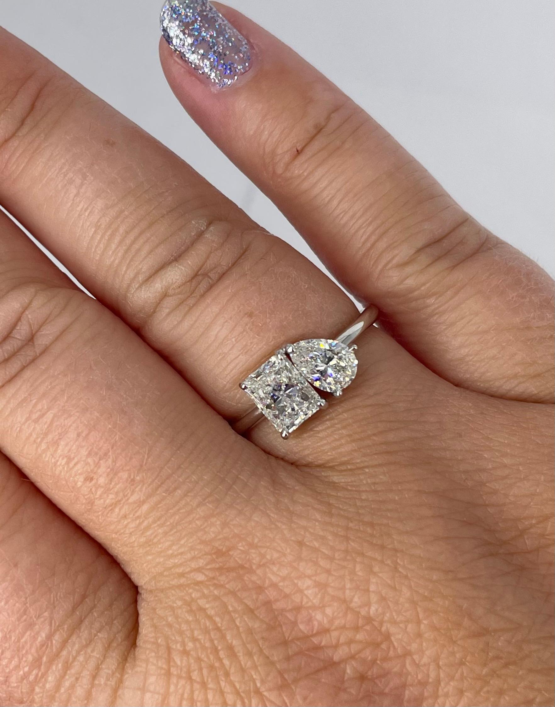 This sweet, sparkly ring is beautiful as a fashion piece or to symbolize you and your loved one. The ring features two diamonds: a 0.51 carat pear diamond, G color and VS1 clarity, and a 0.90 carat GIA certified radiant diamond, I color and I1