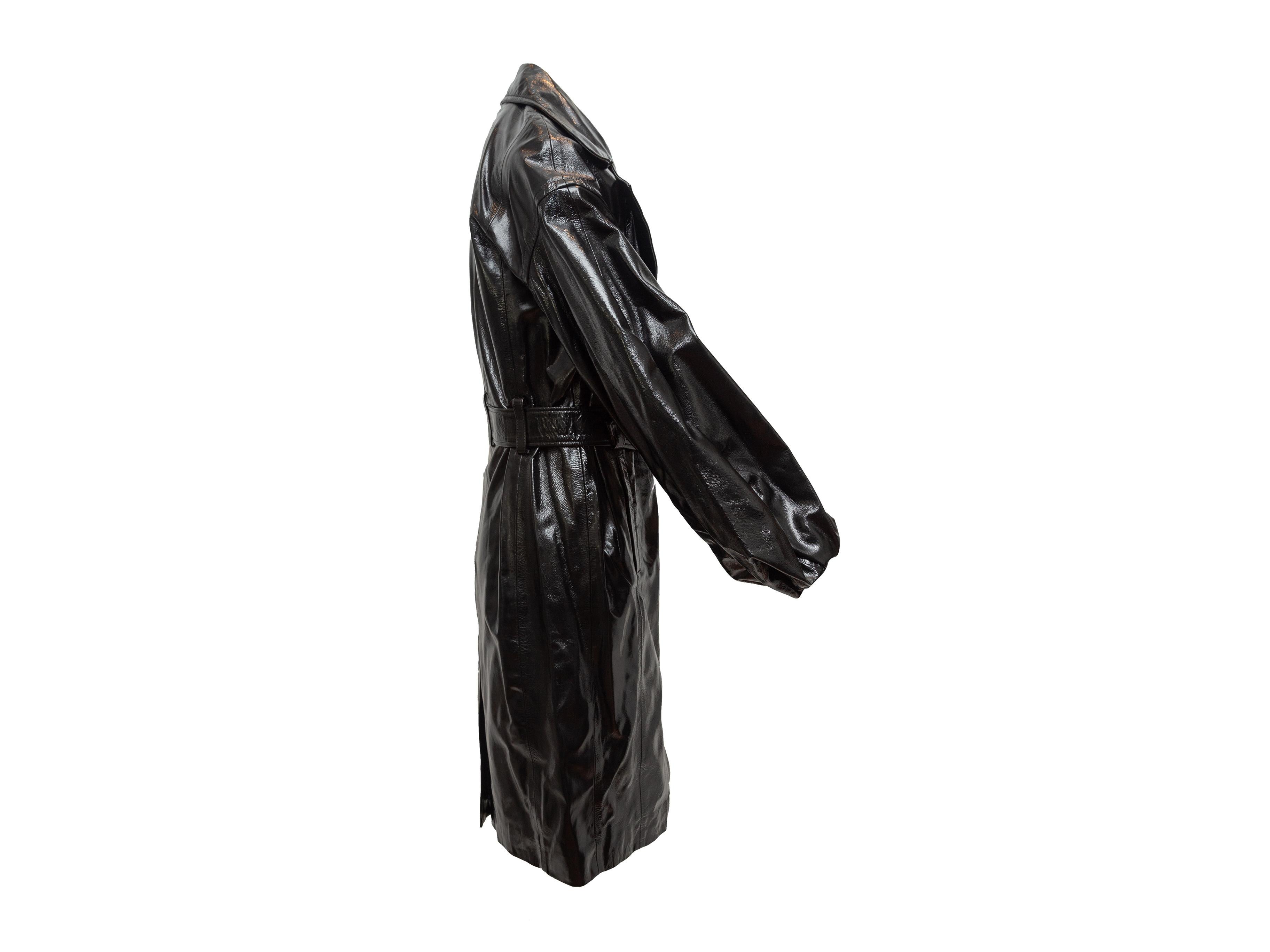 Product details: Black patent leather Antonia trench coat by J Brand x Halpern. Notched collar. Bell sleeves. Belt at waist. Dual hip pockets. 19