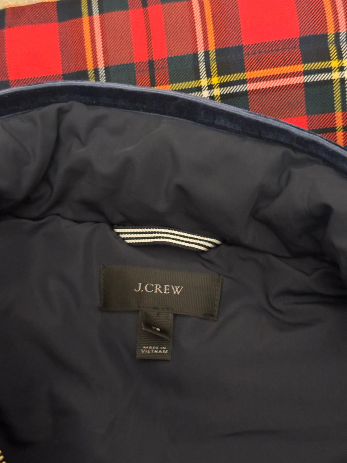 A colourful and cosy body warmer/gilet by J Crew. In a colourful red check , the warmer has an attractive blue velvet trim of the pockets. It has a central zip opening and zip openings on both sides for comfortable wearing. 
Size XS Bust up to 37'',