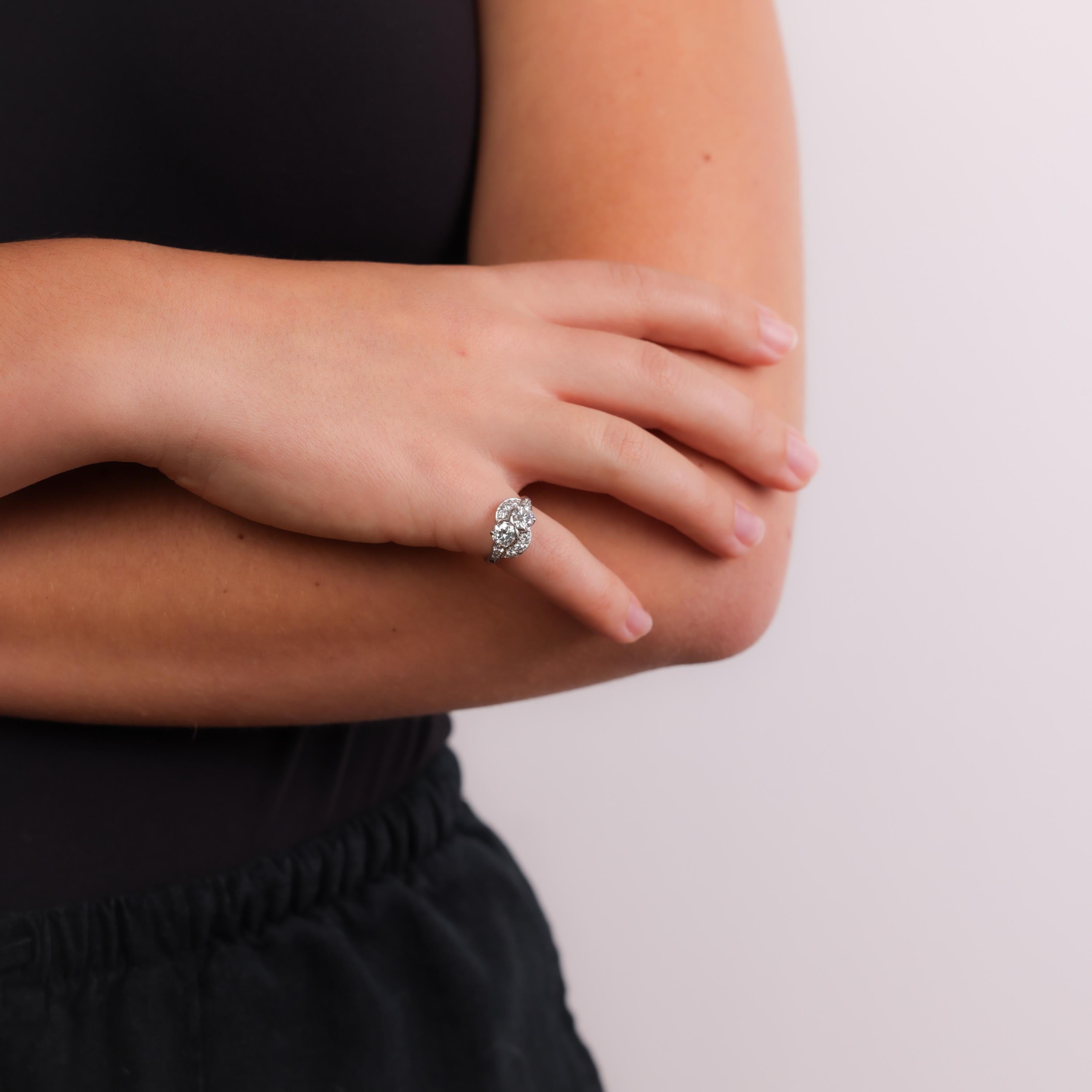 This Retro J.E. Caldwell platinum ring showcases two dazzling diamonds complemented by sparkling accent stones, offering timeless elegance and exceptional craftsmanship from the 1940s.

Brand: J.E. Caldwell
Center stones: 2 round brilliant cut