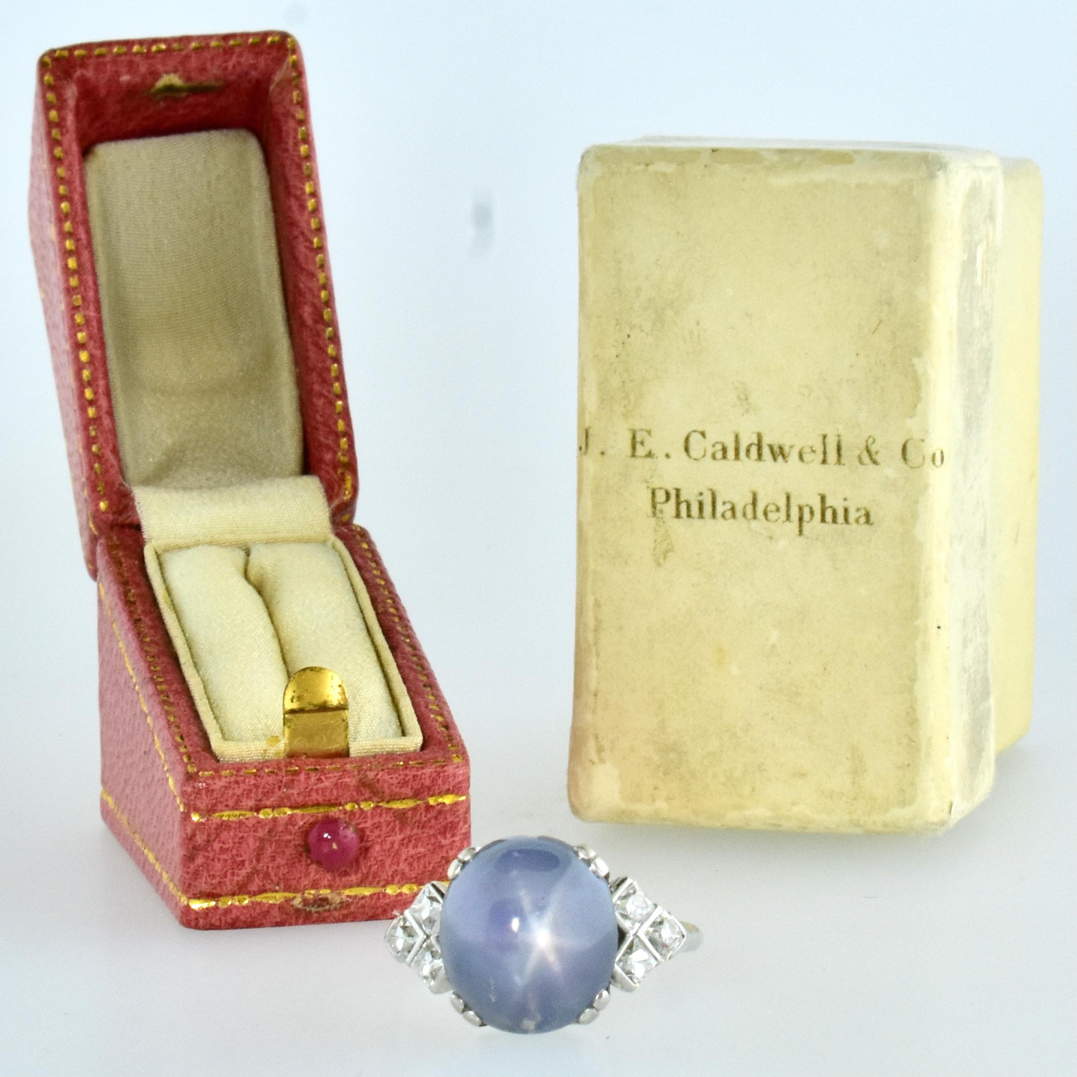 Art Deco platinum, diamond and fine natural Star Sapphire ring by the famous American jewelry House of J. E. Caldwell.  The sapphire displays a pleasing light to medium blue color and the star is evident. The rays, called asterism, start at the top