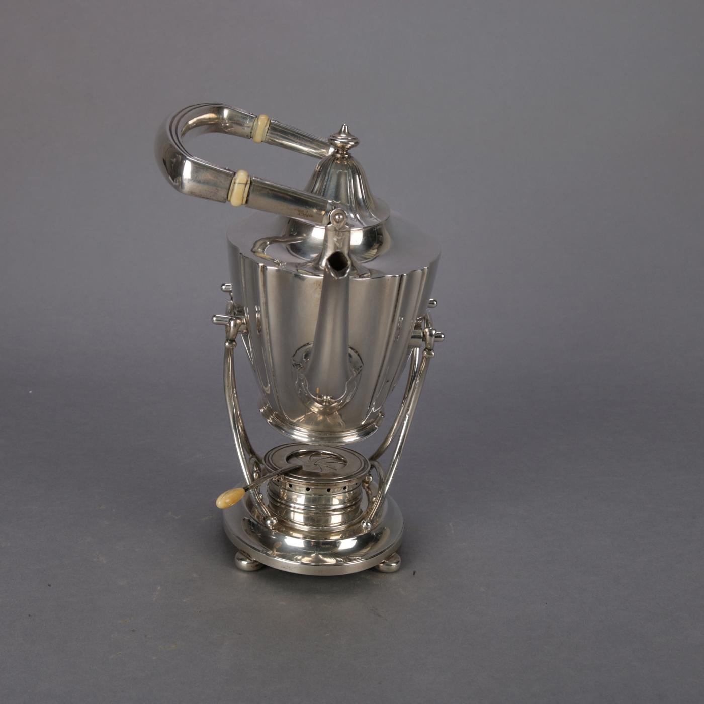 silver teapot on stand with burner