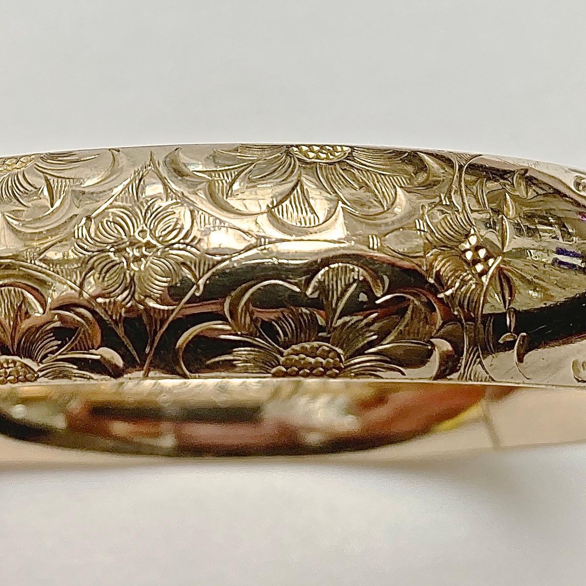 JFSS wonderful antique gold filled engraved bangle bracelet.  It opens with a push button and has an internal bar for strength.  The bangle is slightly oval, the inside measurements are 5.8m / 2.28 inches by 5.5cm / 2.1 inches, and the width is